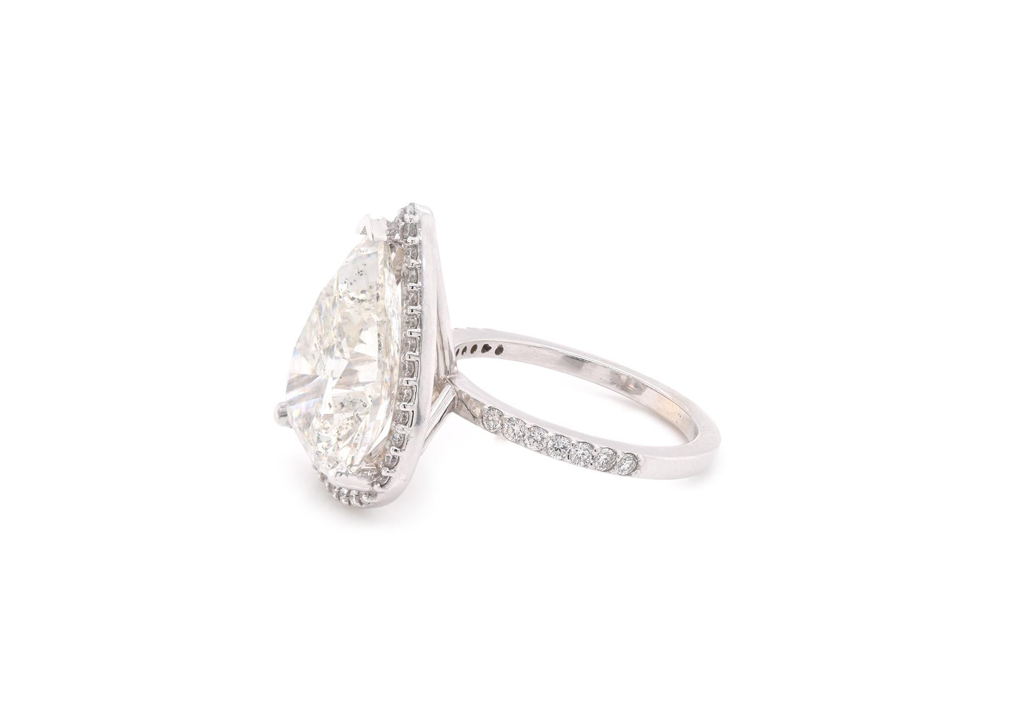 Material: 14k white gold 
Center Diamond: 1 pear cut diamond = 10.09ct  
Color: I
Clarity: I1
Mounting Diamonds: 47 round brilliant cuts = 0.51cttw
Color: G-H
Clarity: VS2-SI1
Ring Size: 8 (please allow two additional shipping days for sizing