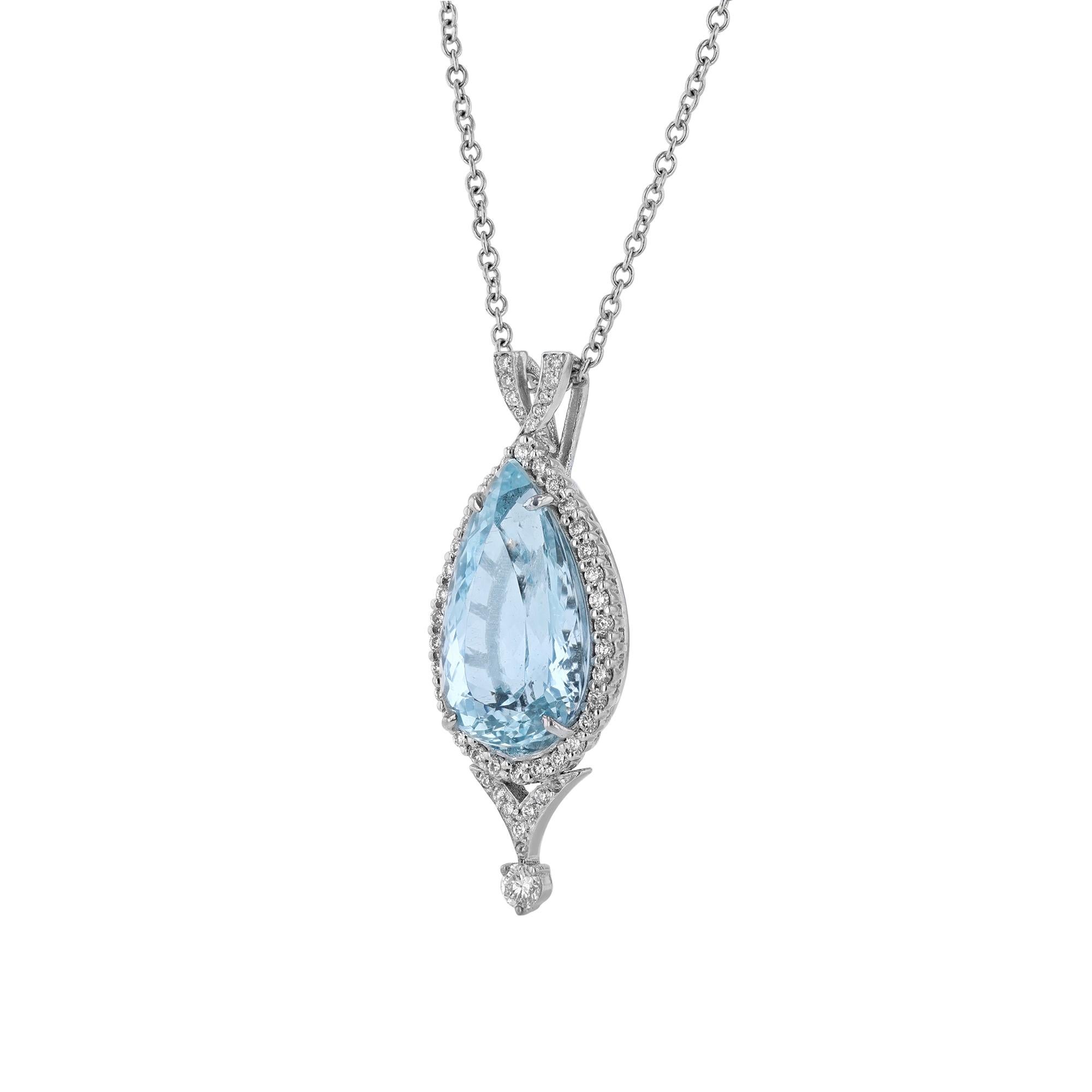 This necklace is made in 14K white gold and features a pear shaped aquamarine weighing 9.43 carats. With a halo and enhancer of 50 round cut diamonds weighing 0.62 carat.  Necklace has a color grade (H) and clarity grade (SI2). All stones are prong