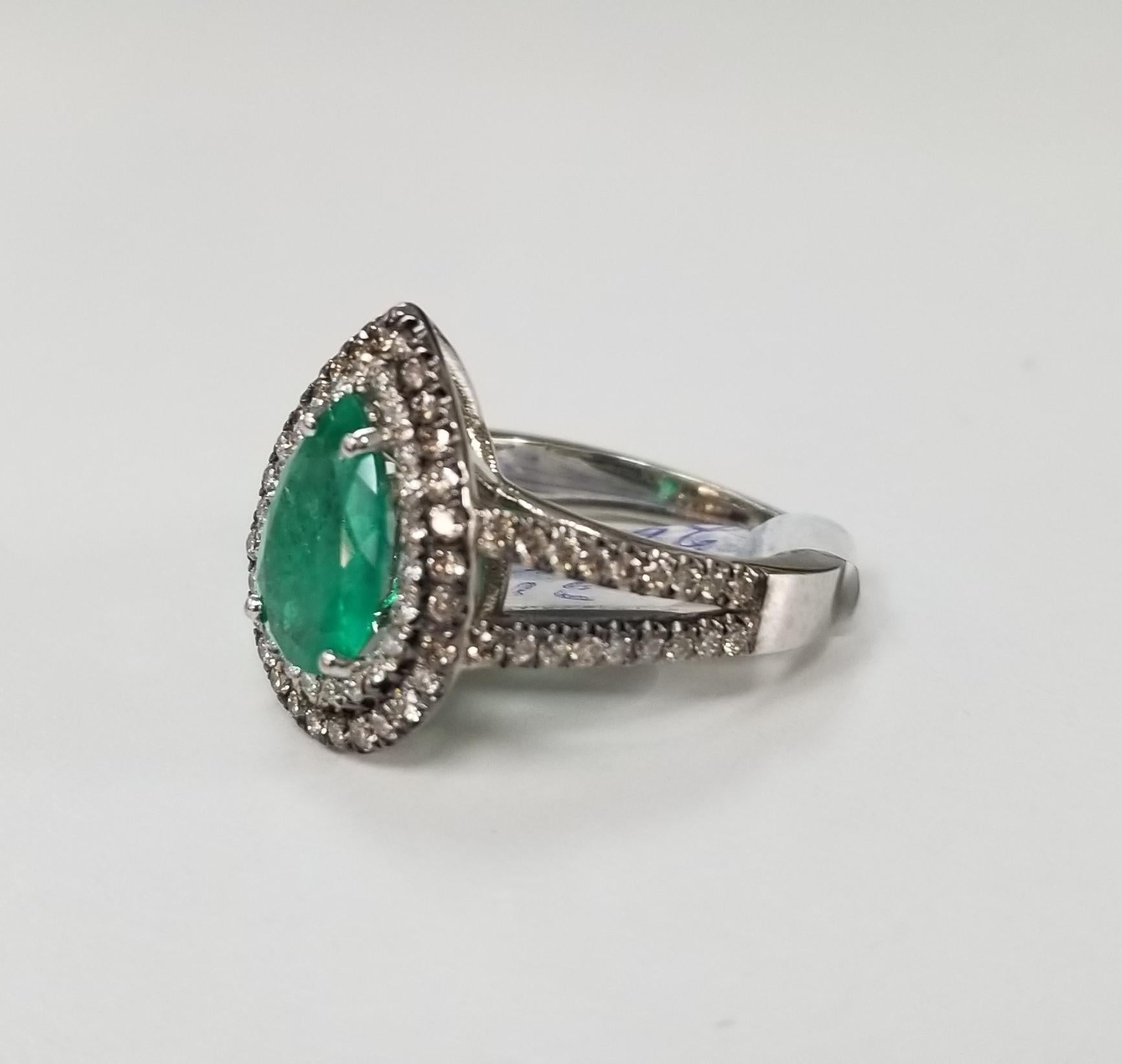 14k white gold pear shape emerald and diamond double halo ring, containing 1 pear shape cut emerald of nice quality weighing 2.20cts. and 91 round full cut white and champagne diamonds of very fine quality weighing 1.40cts. ring is size is 6.5