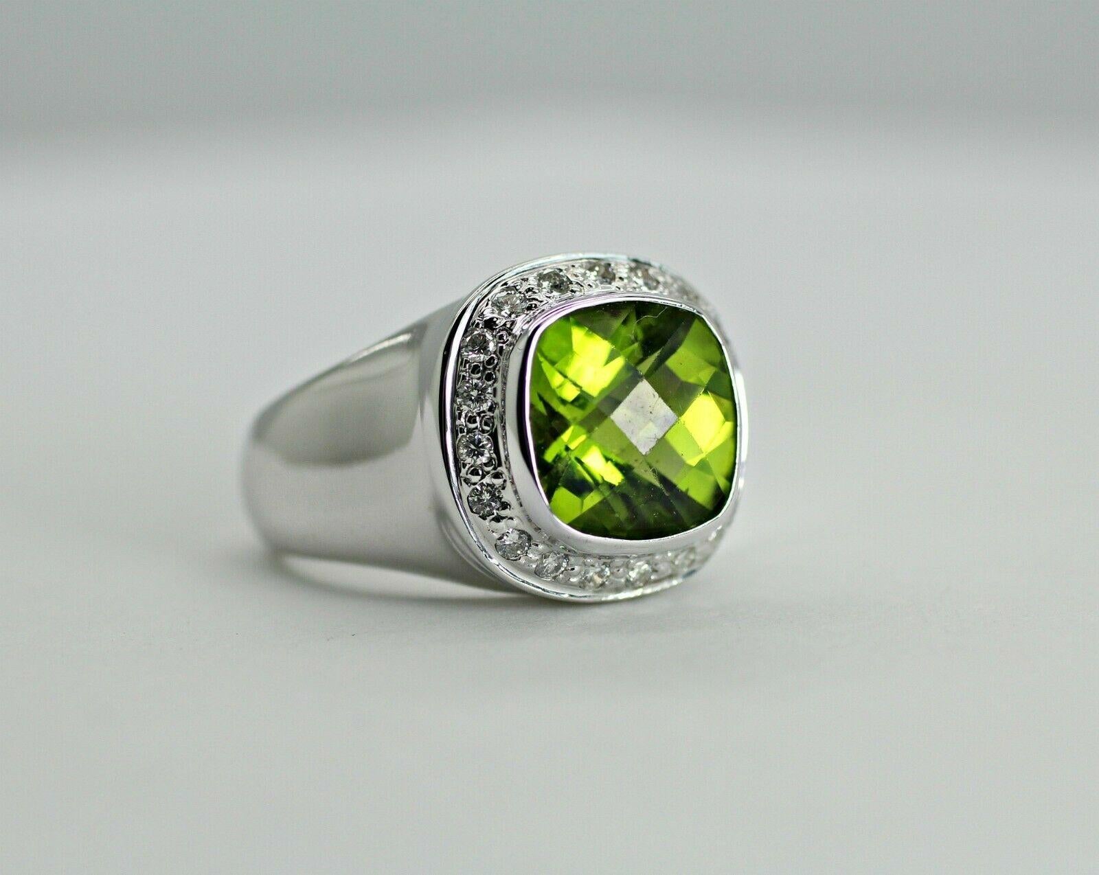  14k white gold peridot and diamond wide ring, containing 
Specifications:
    main stone: peridot ~1.80ct
    additional: diamonds
    diamonds: 20 pcs
    carat total weight: 0.24
    color: G
    clarity: vs2-SI1
    brand: UNBRANDED
    metal: