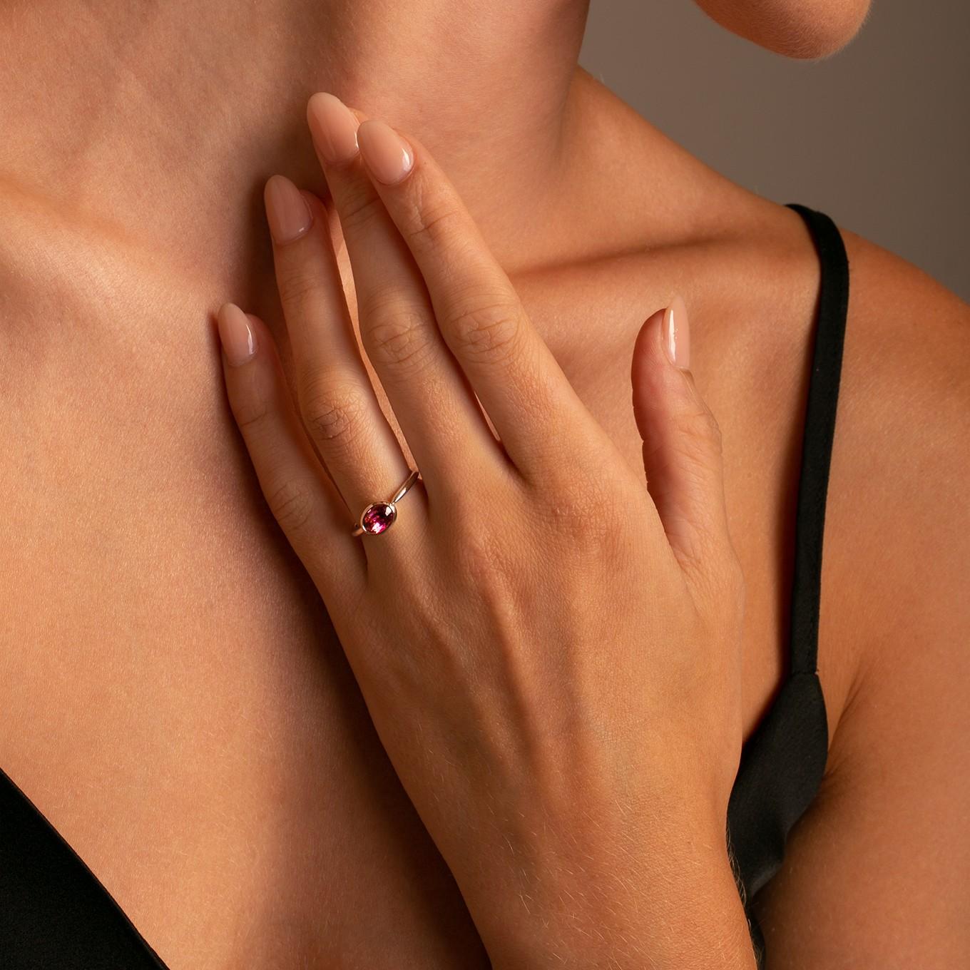 This ring features a bright pink oval tourmaline set in a East to West Horizontal bezel setting to create a decidedly modern and fresh aesthetic.

Perfect to be worn alone or stacked with other rings, this pieces adds a touch of effortless luxury to