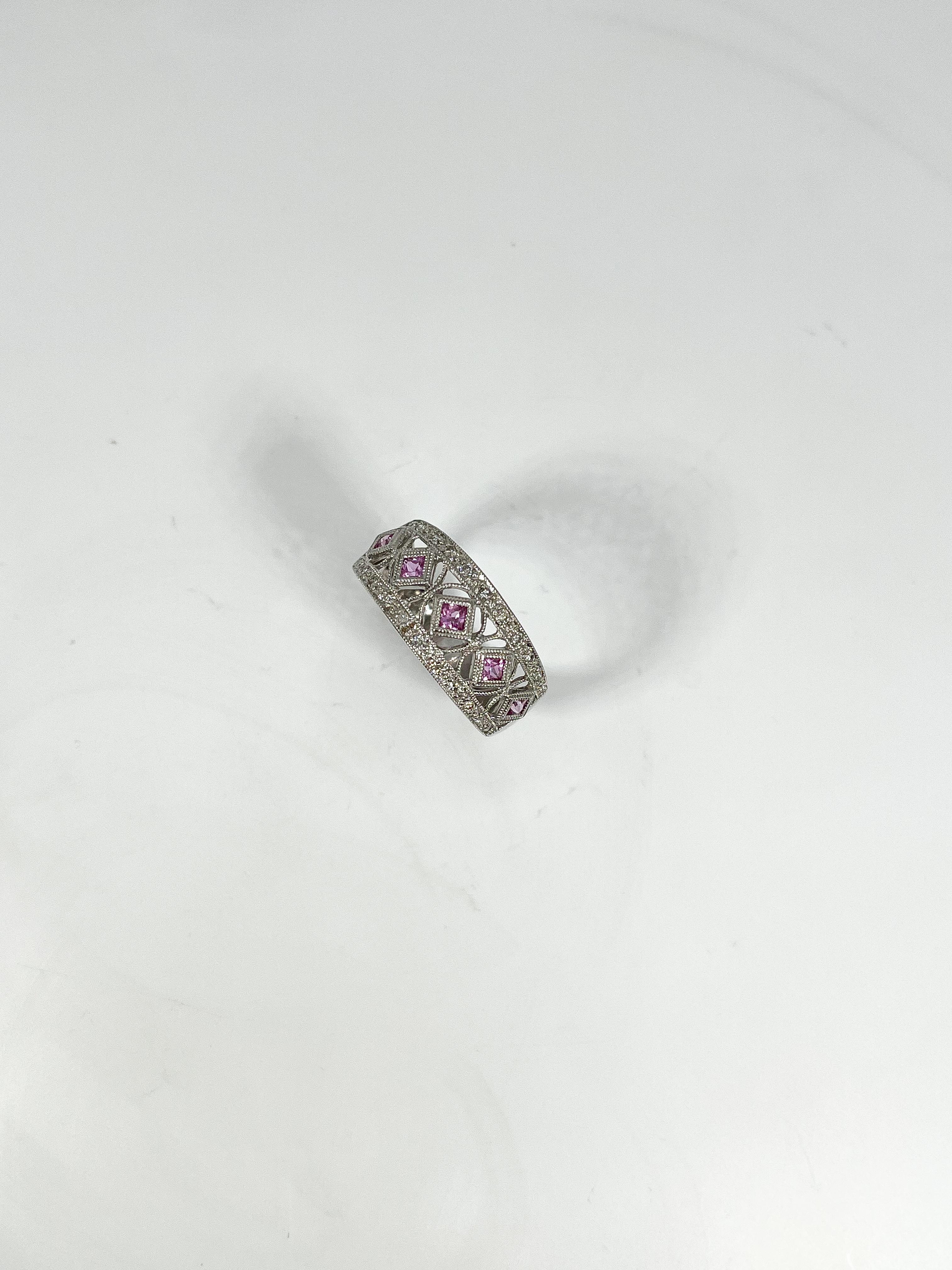 14k white gold pink sapphire .50 CTW and diamond .25 CTW band. 5 total princess cut pink sapphires and diamond accents. The rings width is 9.1 mm, measures a size 8 1/4, and has a total weight of 4.18 grams.