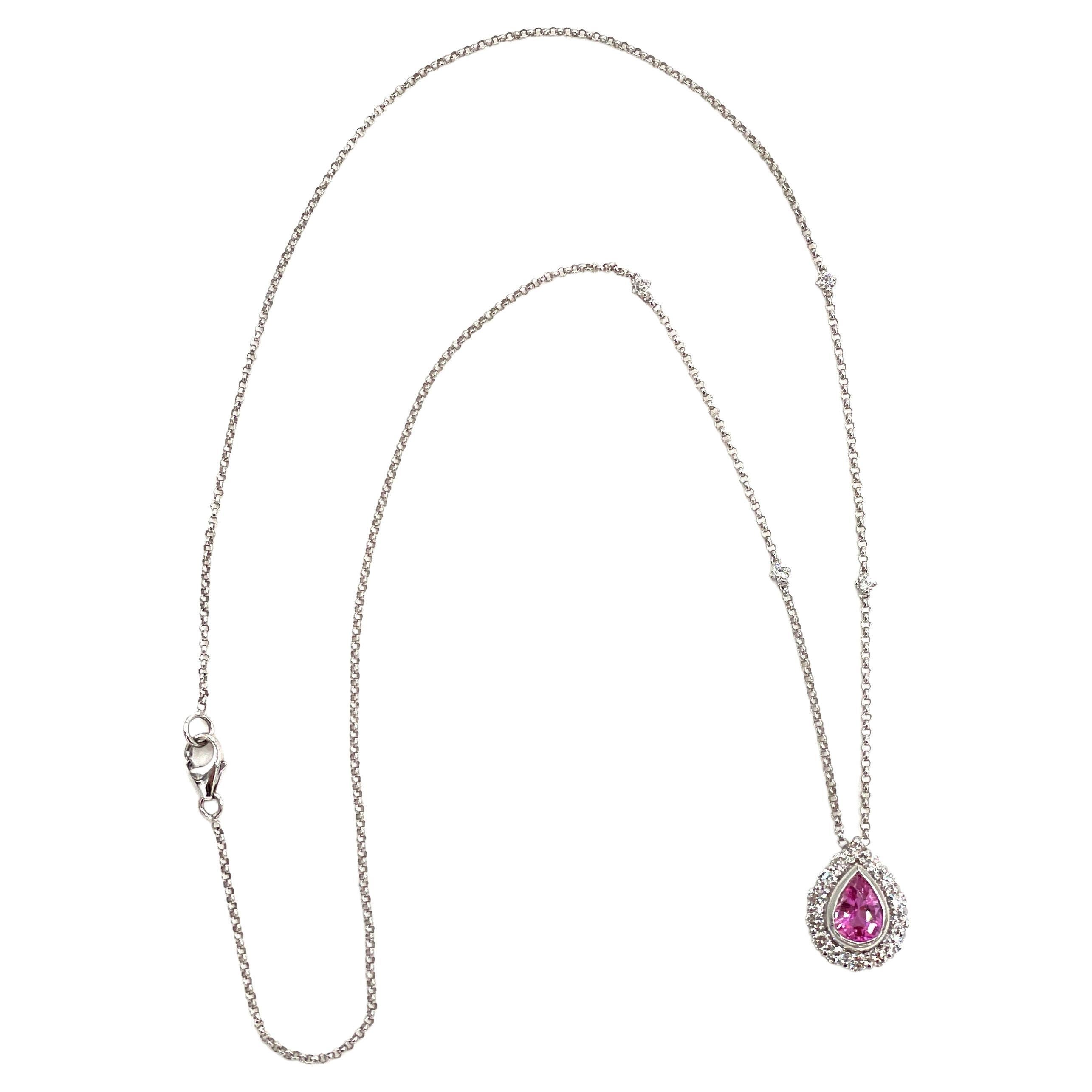 14K white gold halo pendant necklace with 18 round brilliant-cut diamonds 0.30 carats and one center bezel set pear shape pink sapphire 0.74 carats.

* 16 inches long