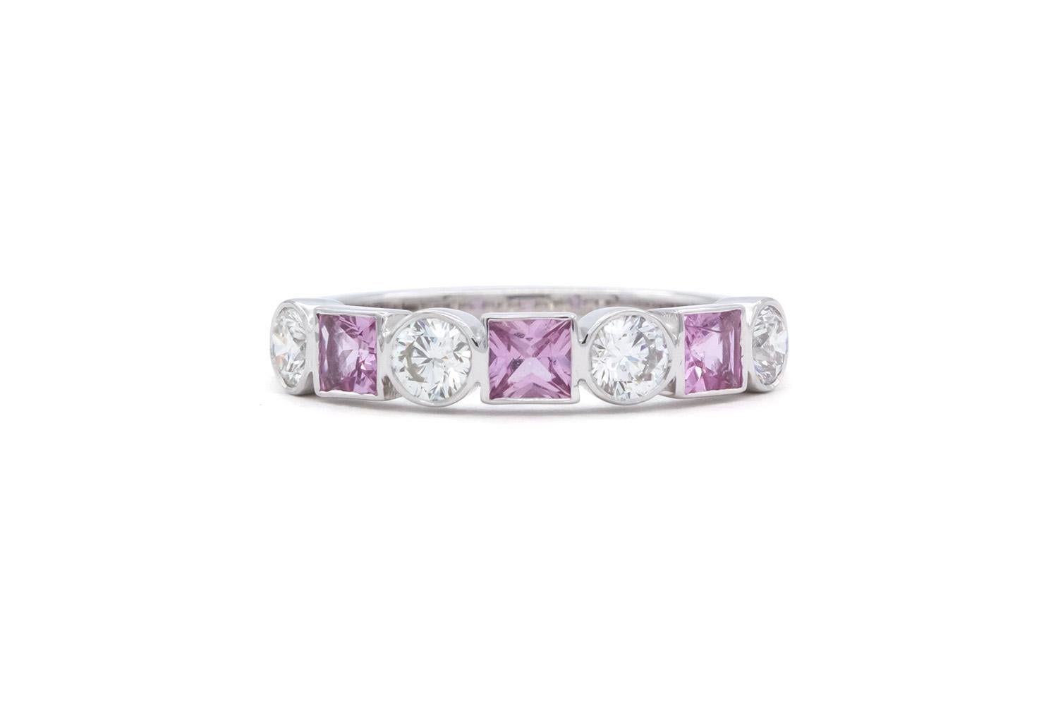 We are pleased to offer this 14k White Gold Pink Sapphire & Diamond Fashion Stacking Ring. This stunning ring feature 0.33ctw natural princess cut pink sapphires accented by 0.40ctw G-H/VS-SI round brilliant cut diamonds all bezel set in a 14k white