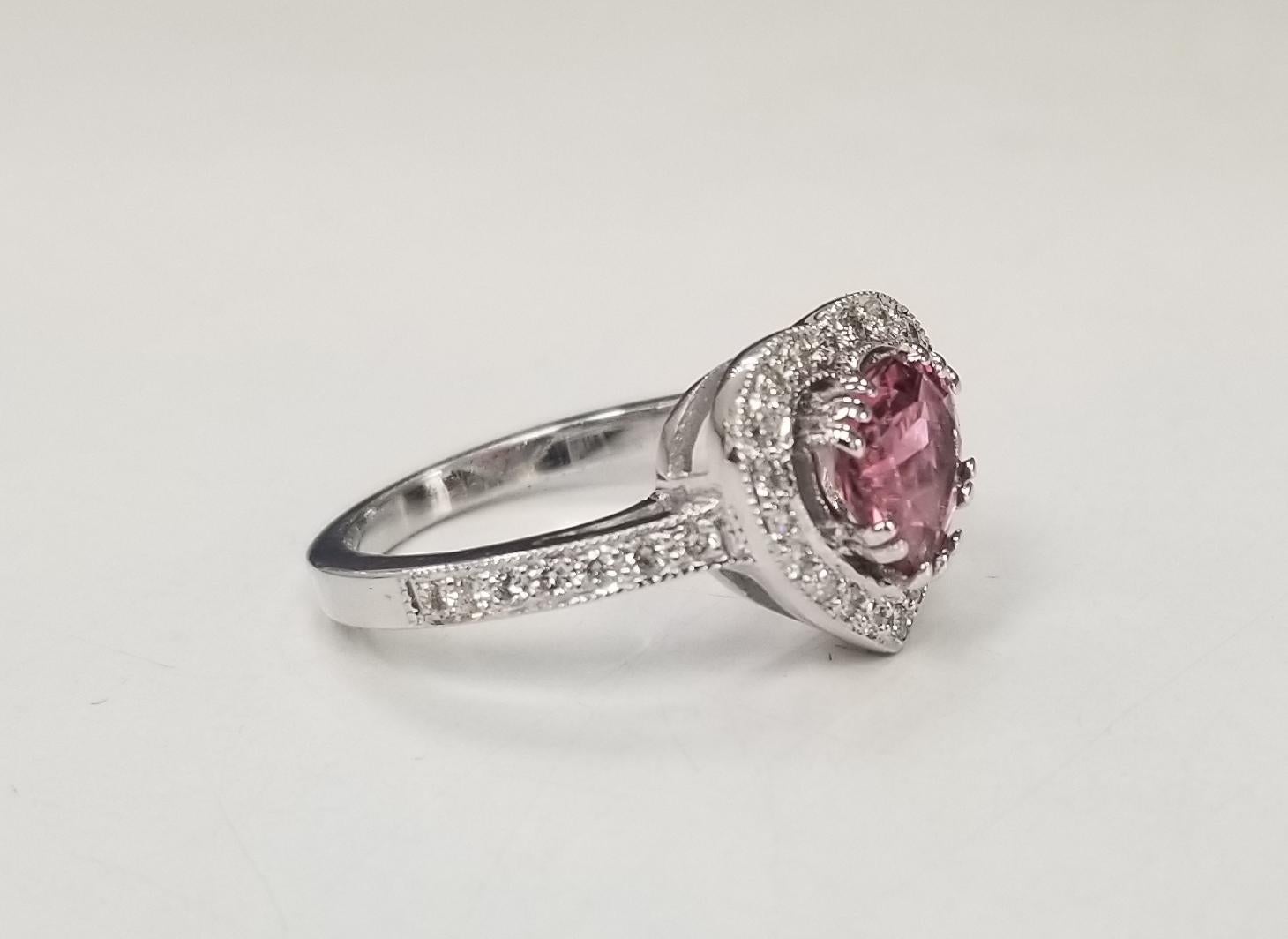 14k white gold pink tourmaline weighing 1.30cts. and diamond halo ring also 34 round full cut diamonds of very fine quality weighing .35pts.  the ring is a size 6.5 and can be sized to fit for free.