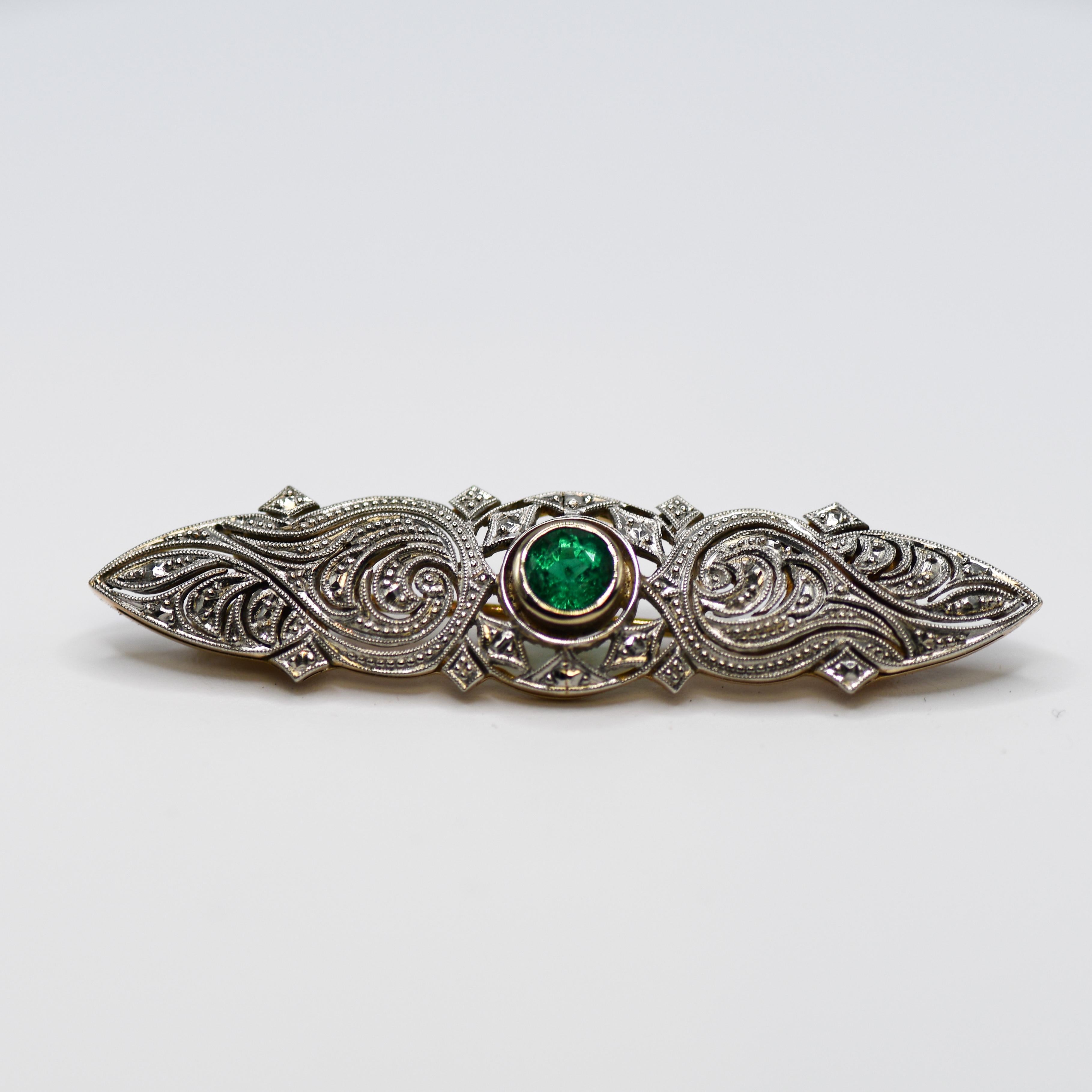 Antique Art Deco brooch with natural emerald.
The top of the brooch tests platinum and the back and pin tests 14k.
Total weight is 6.2 grams.
  Round brilliant cut Colombian emerald, .60 carats, very good color.
Excellent metal work in the