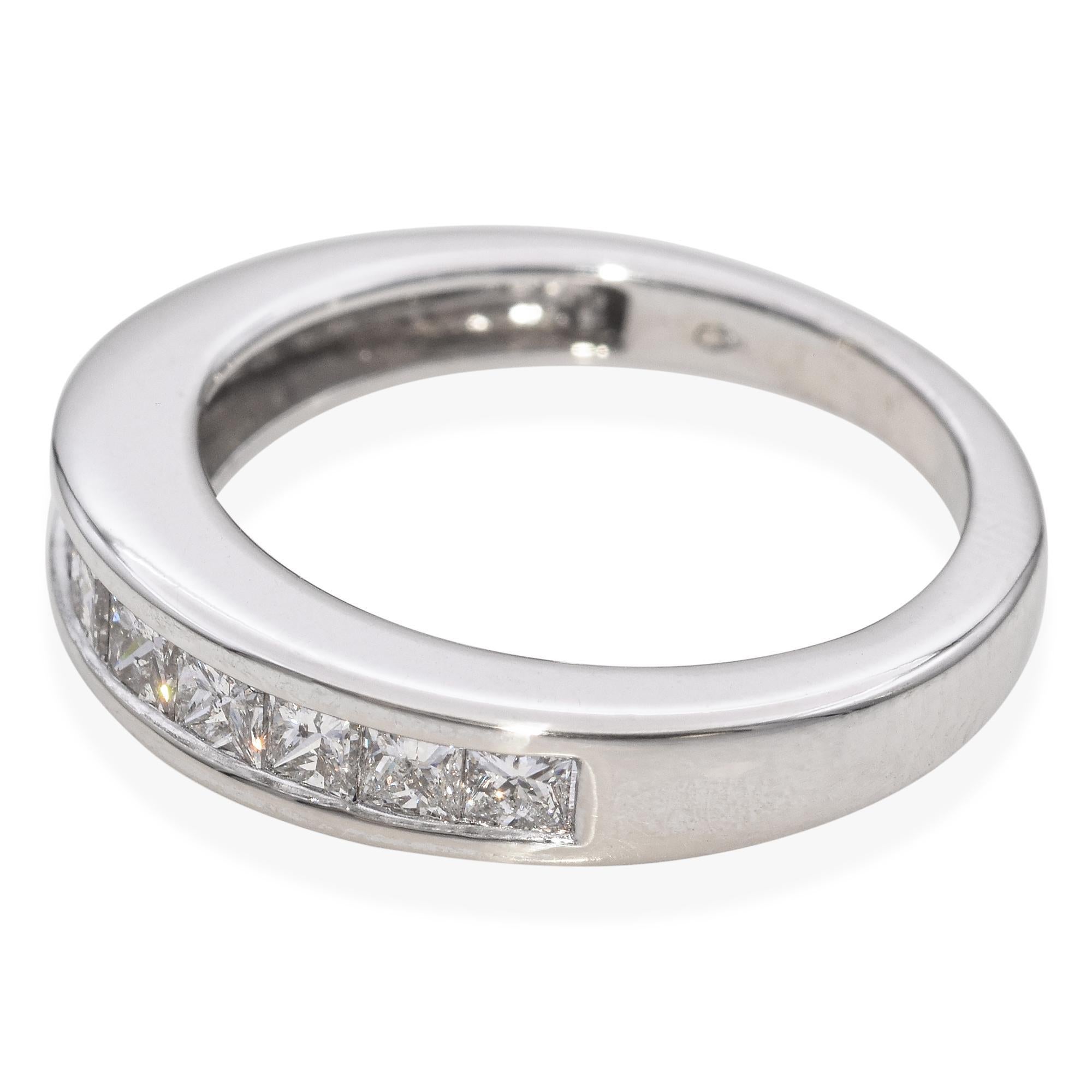 A contemporary wedding ring featuring princess-cut white diamonds. The diamonds are channel set in a sleek tapered band of 14k white gold, showcasing a modern and elegant design. This refined wedding ring combines modern aesthetics with classic