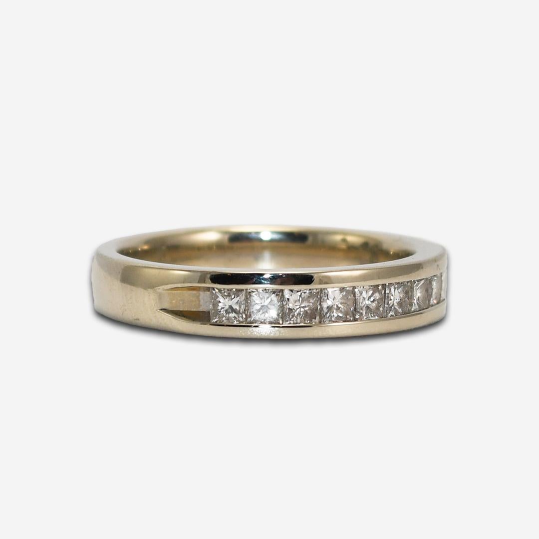 14k white gold band (stamped 14k) with diamonds.
The ring weighs 4.3 grams.
There are nine princess cut diamonds, 0.50 total carats, si clarity, i color, and are set in a channel setting
The ring size is 7 and can be sized to fit.
Overall, very