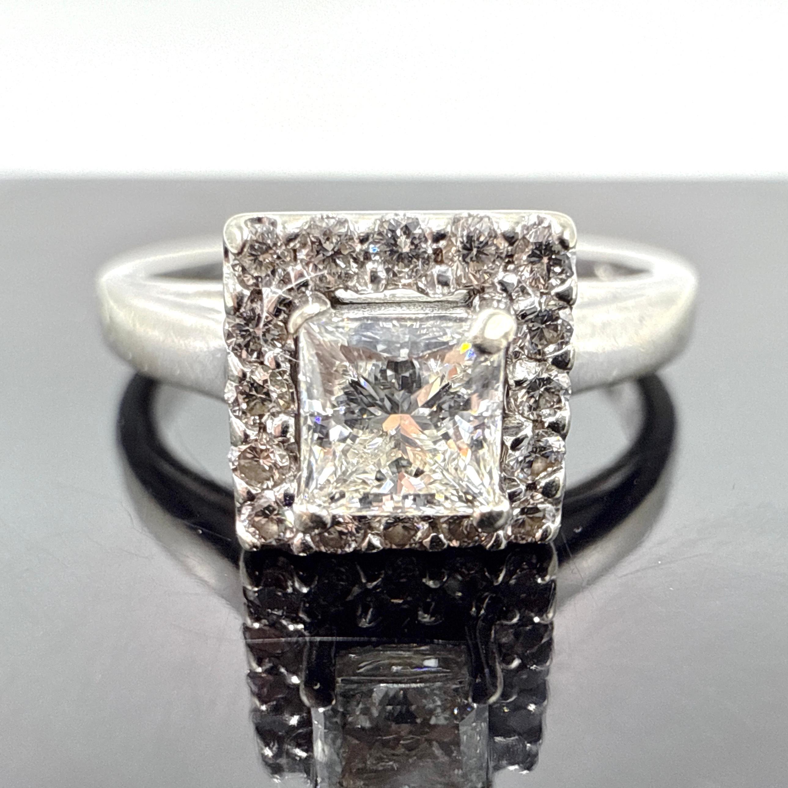 This engagement ring is crafted in 14K white gold and features a wax cast, hand-assembled, and hand-finished construction. The band measures approximately 2.00 mm at the shoulder, tapering to 1.90 mm at the base. A raised four-claw square setting