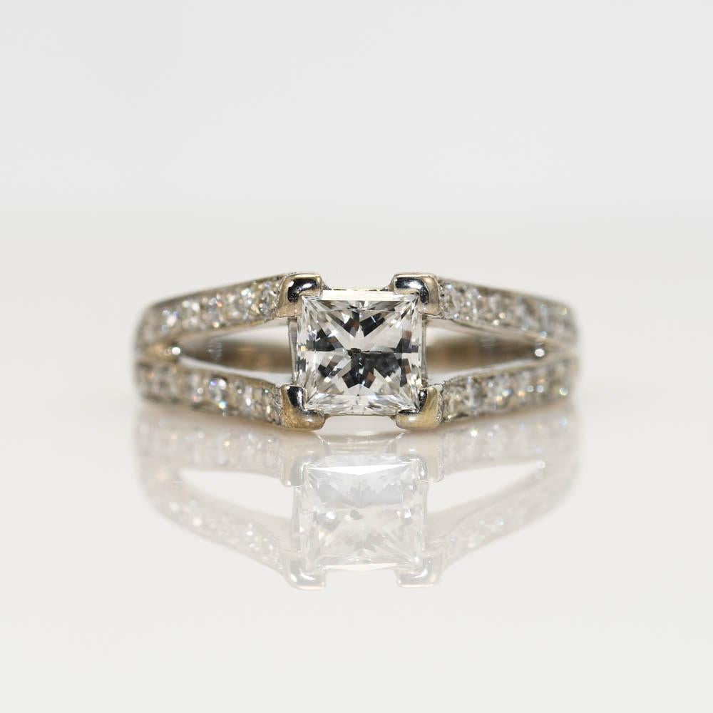 Diamond engagement ring in 14k white gold.
Stamped 14k and weighs 3.9 grams gross weight.
The center diamond is a princess cut and measures .88 carats using a leveridge gage, G to H color, i1 clarity.
The side diamonds are round brilliant cuts, .32