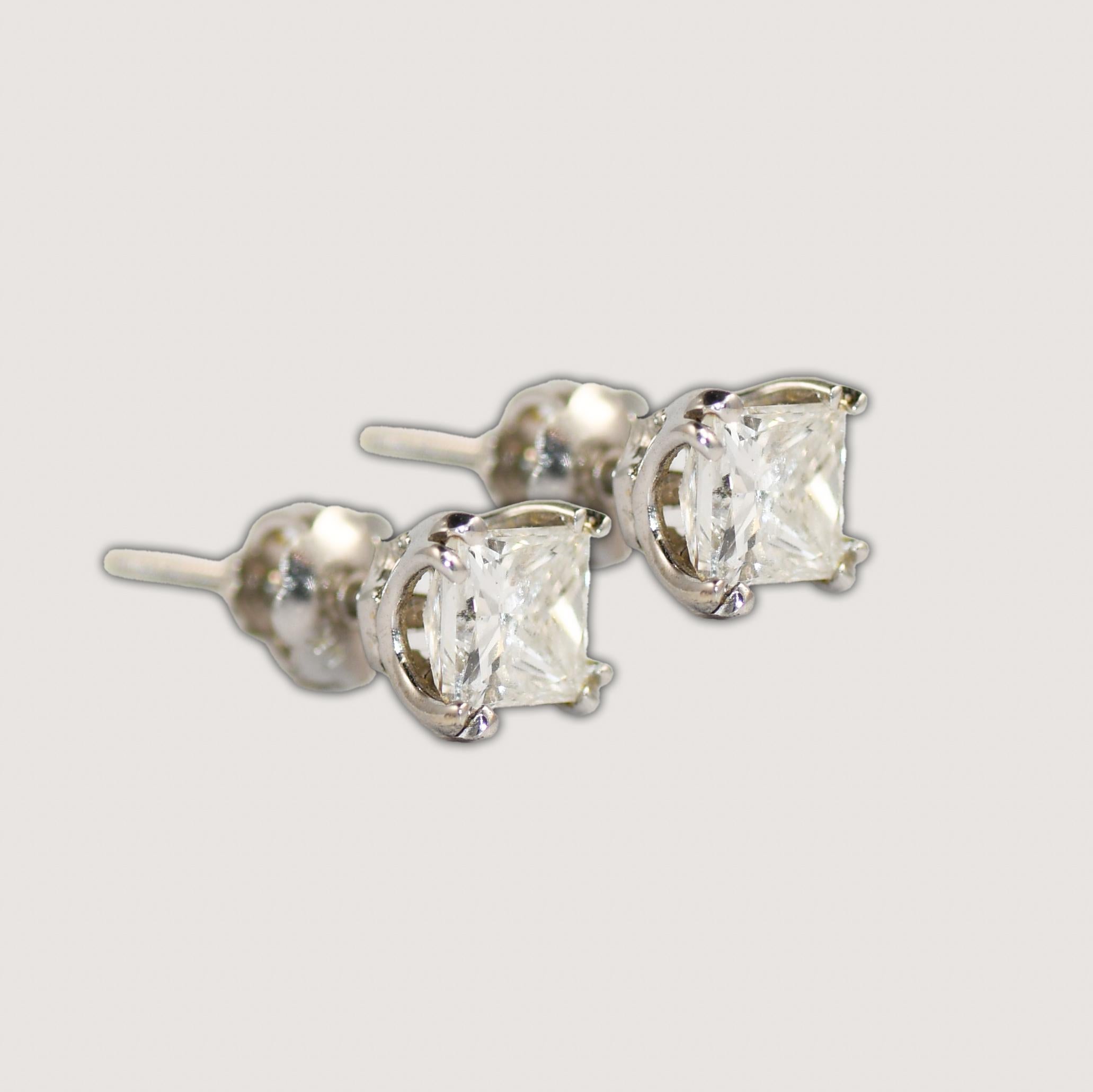 Princess cut diamond stud earrings in 14k white gold.
Stamped 14k and weighs 1.2 grams gross weight.
The diamond is square with a brilliant cut underneath, 1.00 total carats, H to i color, i1 clarity.
The backings have screw-back posts.
Excellent