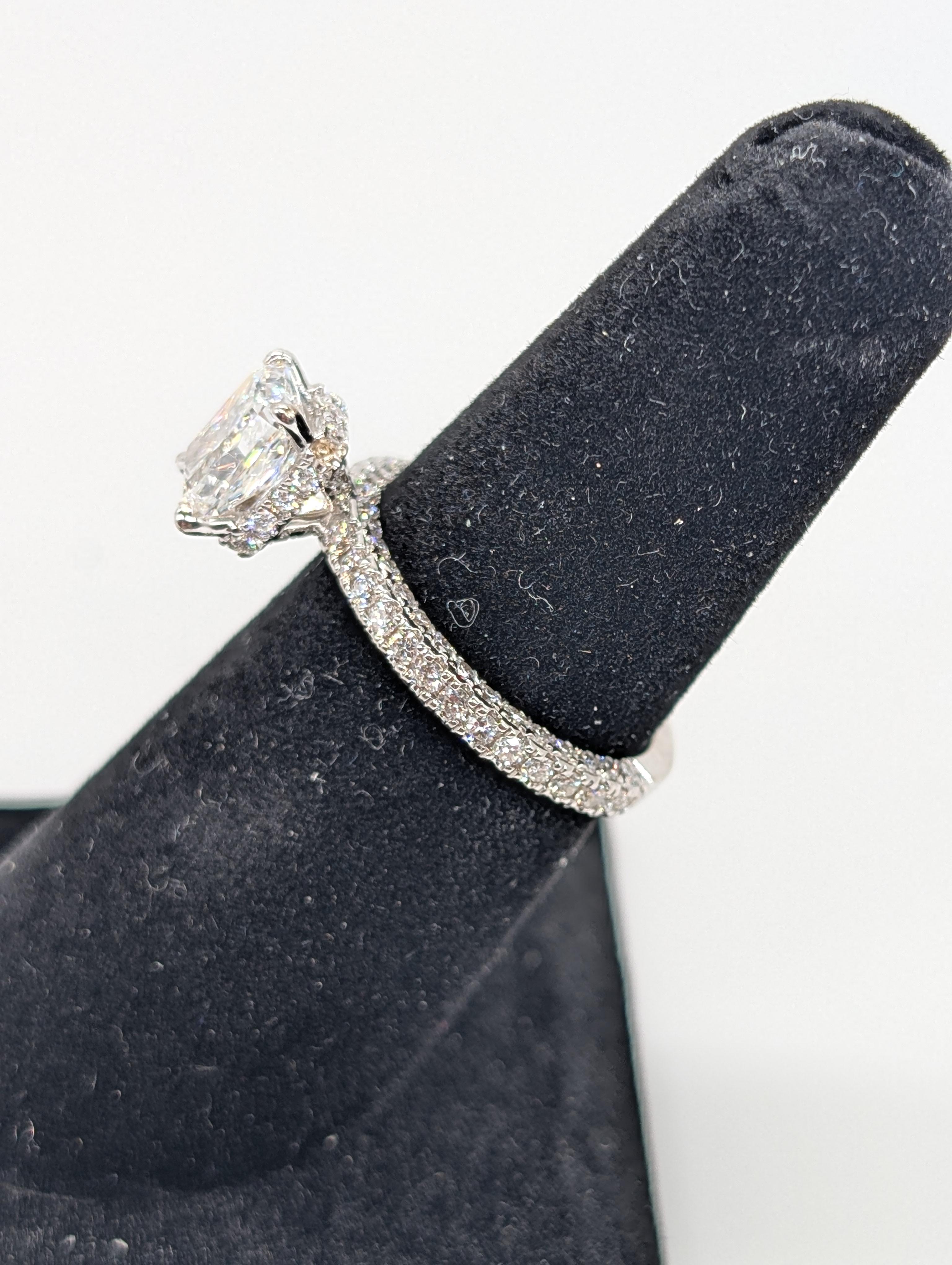 This GIA-certified radiant cut engagement ring is a true masterpiece, featuring a 1.51-carat radiant cut diamond with an E color and VS2 clarity, ensuring exceptional brilliance and clarity. The diamond is set in a unique three-dimensional design,