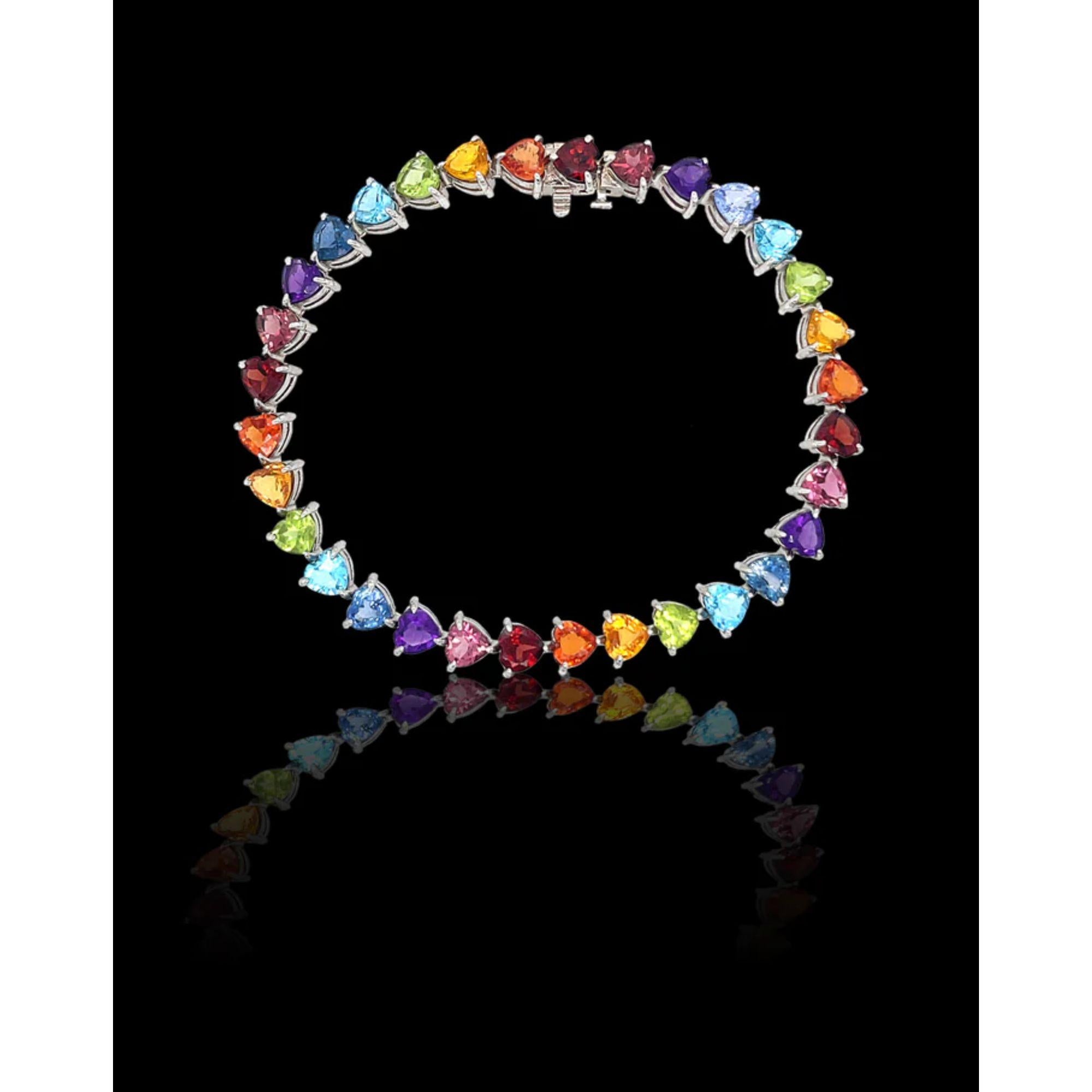 The full rainbow fantasy in the most unique and colorful bracelet to light up your life! This tennis bracelet is like no other consists of heart settings with colored gems and sapphires in the Classic Mordekai rainbow pattern. Goes perfect with our