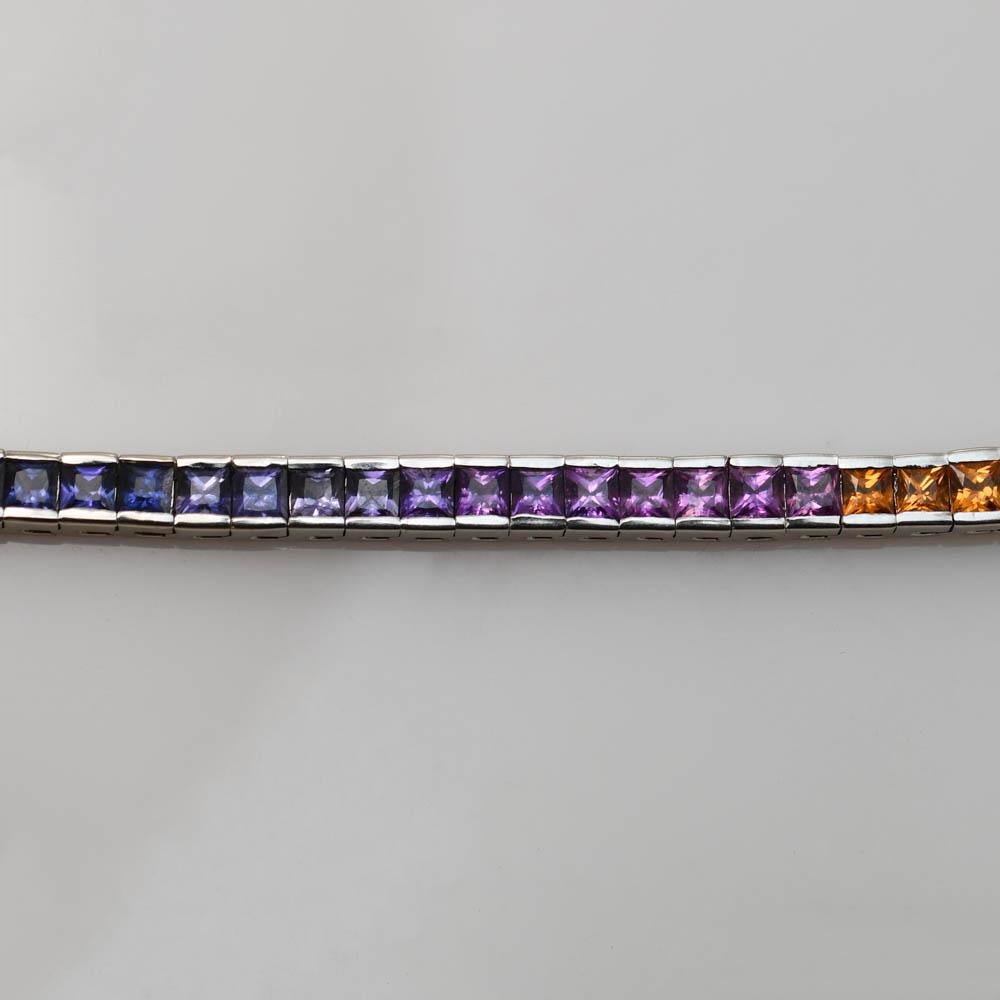 Multi-color, rainbow sapphire bracelet in 14k white gold setting.
Stamped 14k and weighs 27.3 grams gross weight, 24 grams net 14k gold.
The sapphires are natural, but, have a permanent heat treatment to enhance the colors, 15 carats total