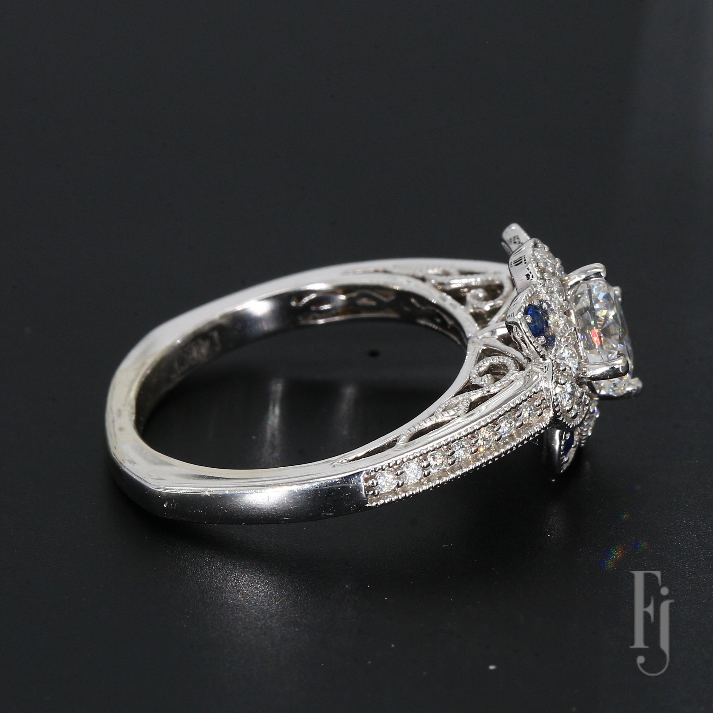 This is a 14k White Gold Ring with a European Shank Mounting 
One 6.1mm Round Center Stone, Surrounded by Twenty-six Diamonds 
Four Blue Sapphire Accent Stones

Ring Size - 6.25
Total Weight - 4.31g