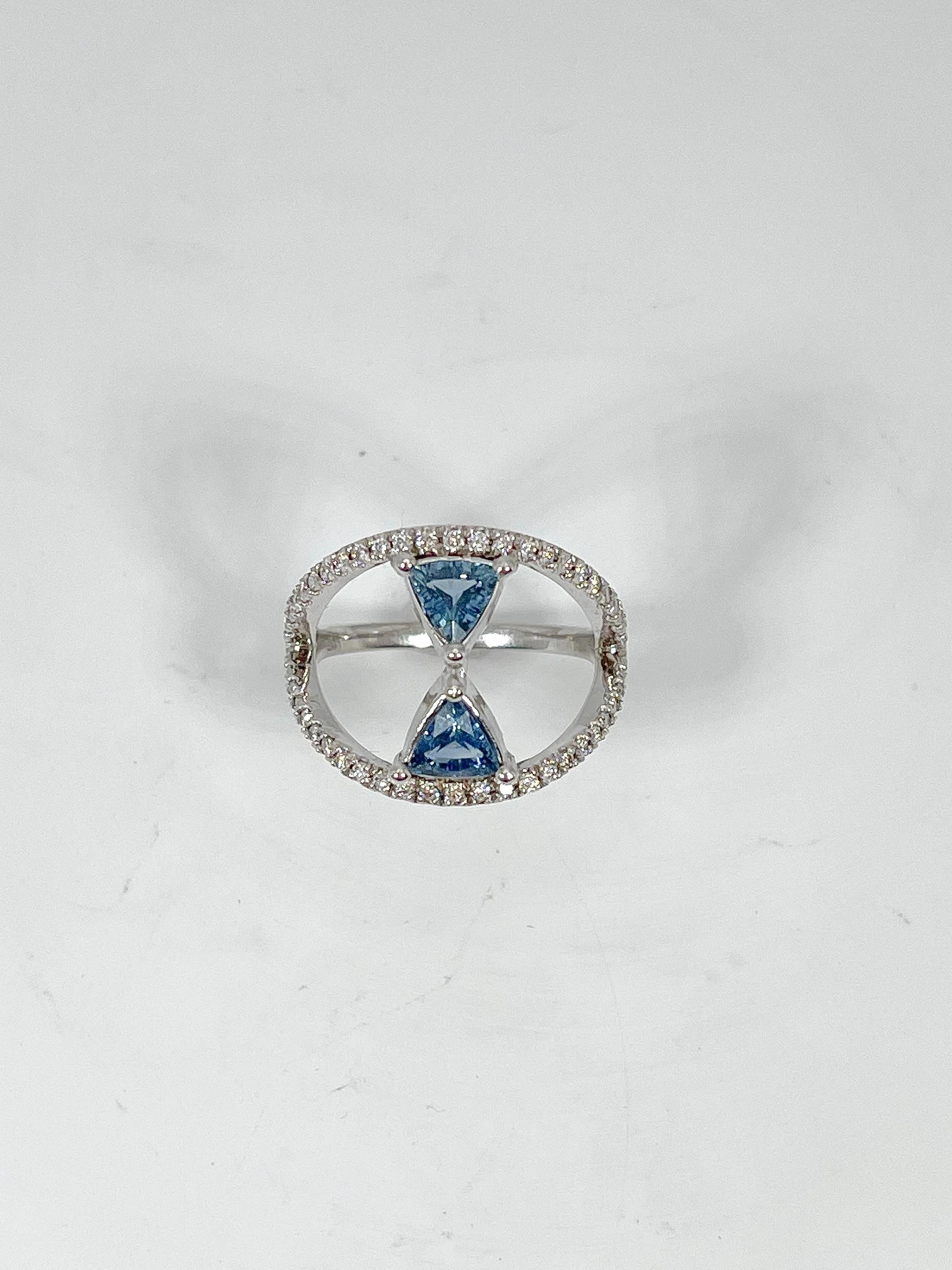 This 14k white gold ring had two .50 carat each sapphires enhanced with .50 ctw diamonds around the sapphires. Ring is a size 7, measures 16.2 mm from top to bottom, and has a total weight of 4.93 grams.