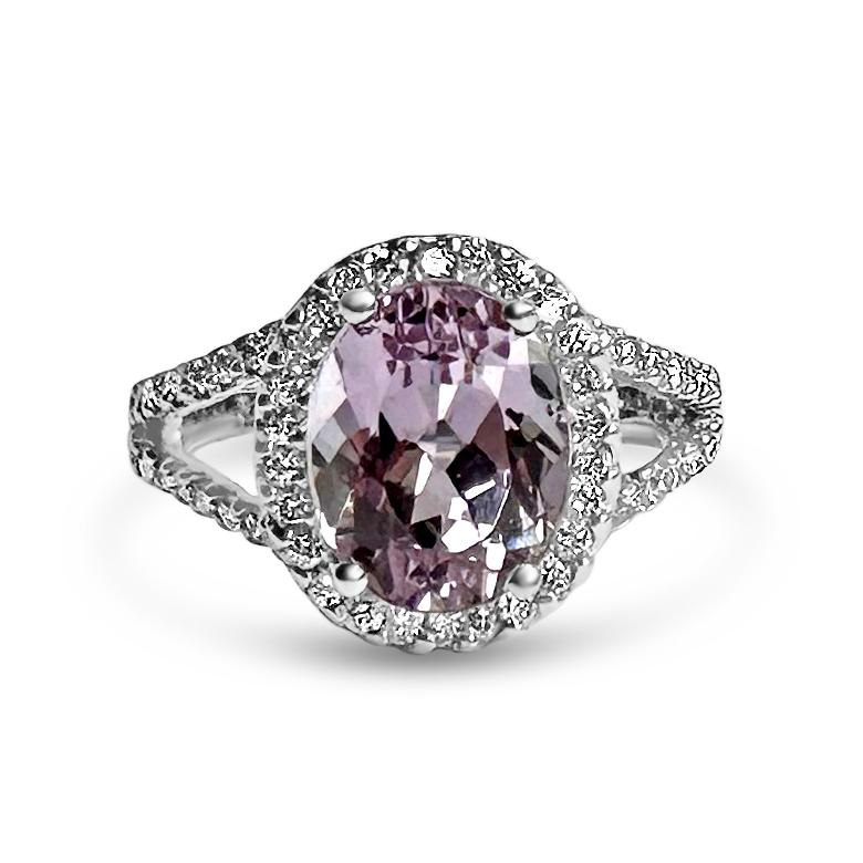 14KW Ring with 68 Round 1.2mm Diamonds 0.62ct G-H SI & 1 Oval 10x8mm Pink Kunzite 3.36cts

Enjoy a touch of femininity with our stunning kunzite set in a classic diamond halo. The ring was handcrafted with the 14K White Gold Ring by Manart Gold &