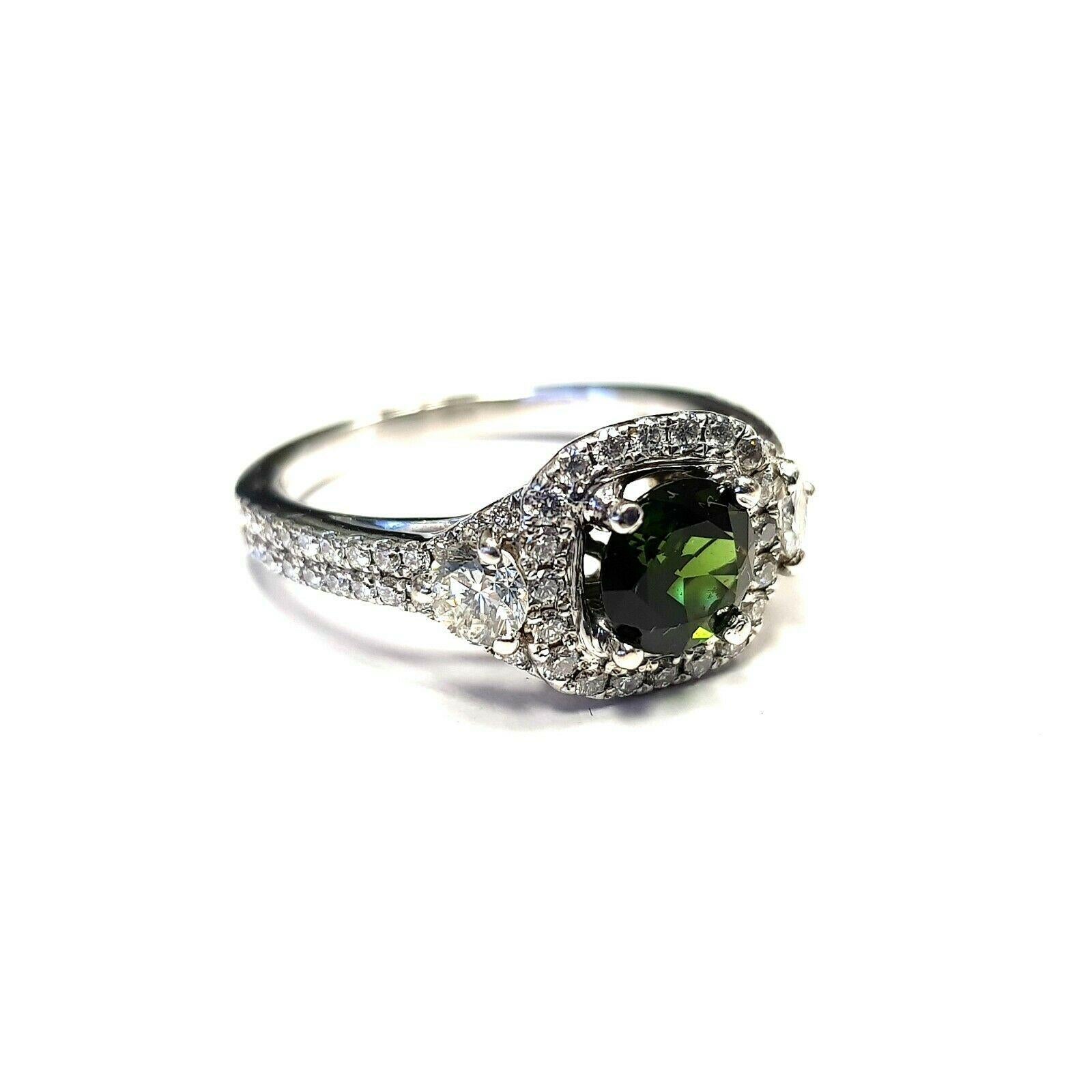  This is a 14k white gold ring with green tourmaline in center and approximately 0.60ct diamonds.  The ring is currently 6.5 in US size, but I can get it resized a bit. 
Specifications:
    main stone: GREEN TOURMALINE 0.80CT
    additional: