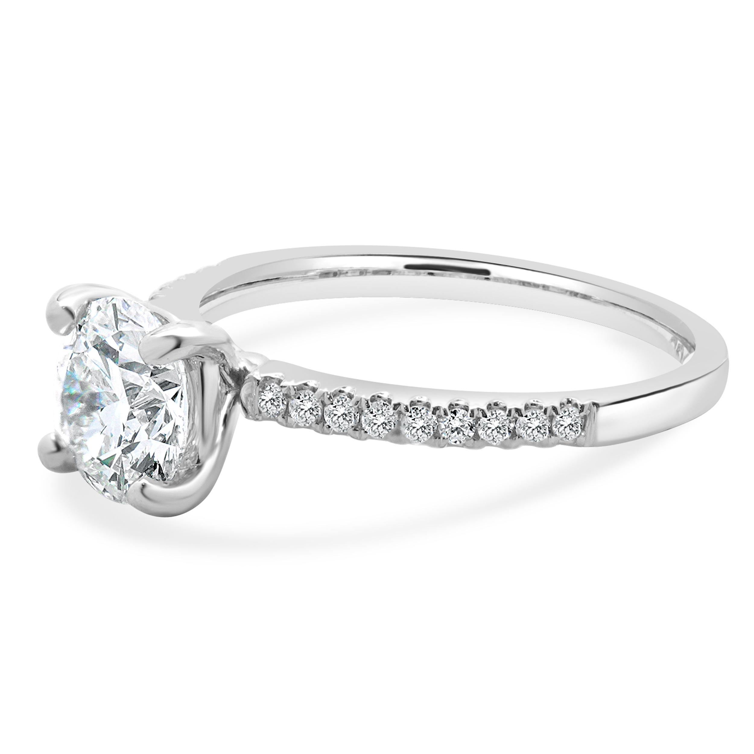 Designer: custom
Material: 14K White Gold
Diamond: 1 round brilliant cut = 1.22ct
Color: F
Clarity: VVS2
Diamond:  round brilliant = 0.14cttw
Color: G
Clarity: SI1
Ring Size: 6.5 (complimentary sizing available)
Weight: 2.64 grams
