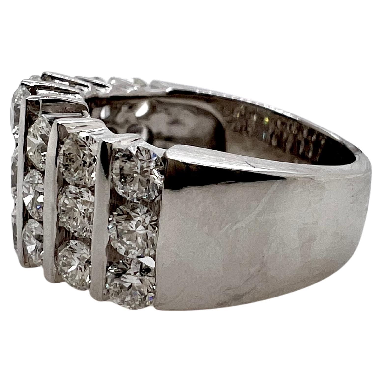 This classic diamond ring has large diamonds channel set vertically to accentuate the finger.  The 18k white gold setting houses the round brilliant diamonds are absolutely glimmers and sparkles.  The heavy weight in the metal allows for daily wear