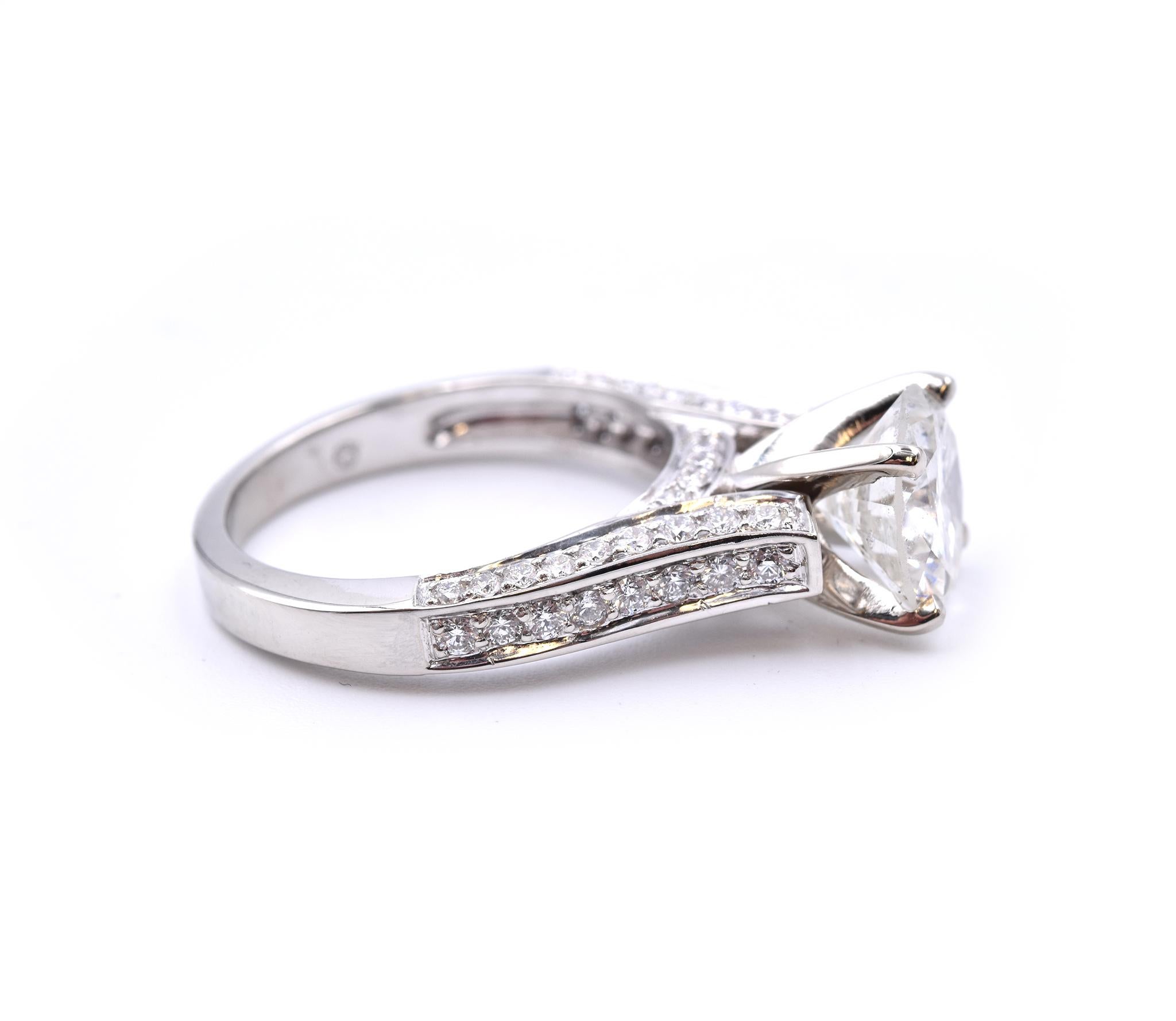Material: 14k white gold 
Diamond: 2.32ct round brilliant 
Color: K
Clarity: I1
Diamond: 62 round brilliant cut = .91cttw
Color: G
Clarity: VS
Ring Size: 7 (please allow up to 2 additional business days for sizing requests)
Dimensions:  ring head