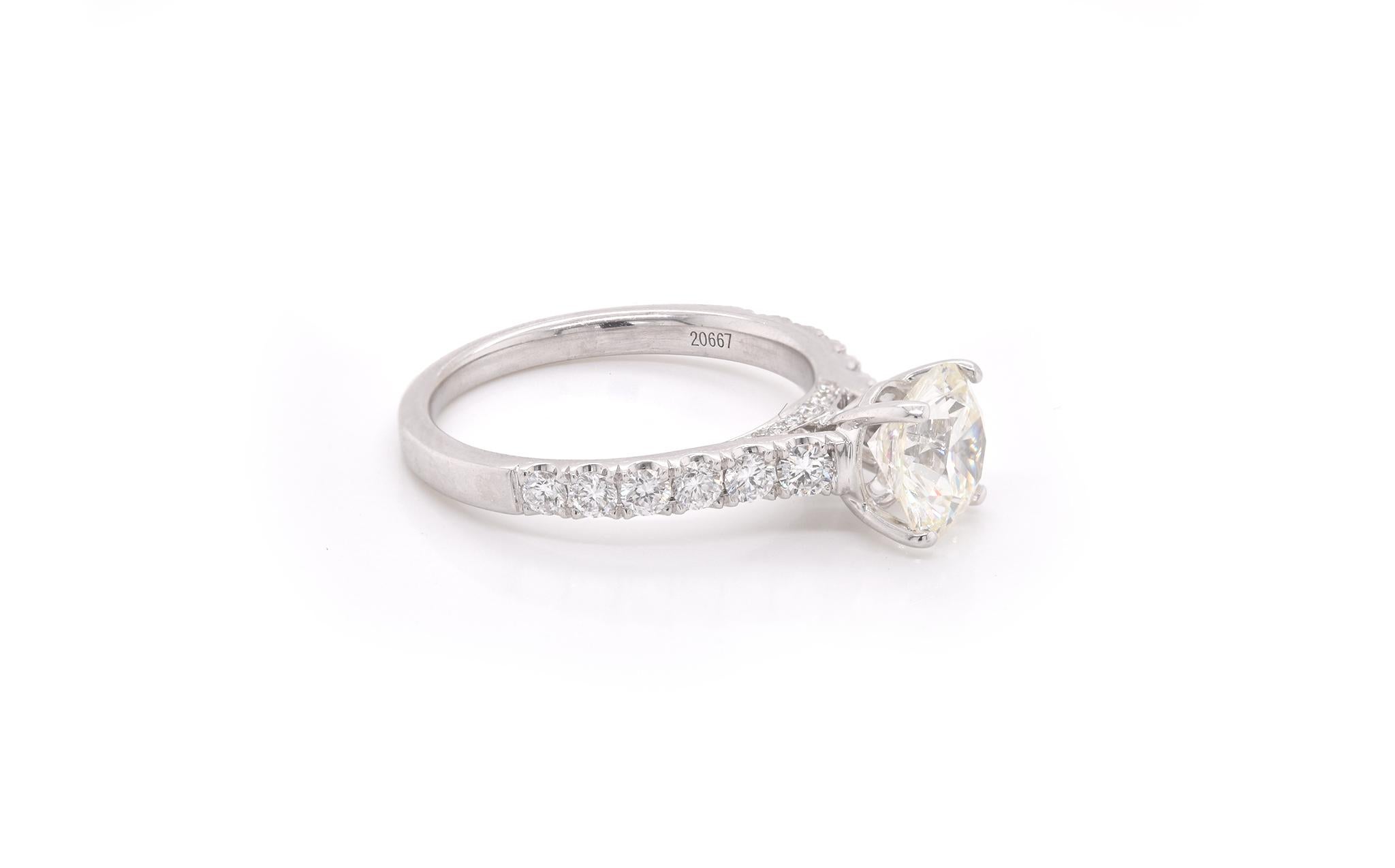Designer: custom design
Material: 14k white gold 
Center Diamond: 1 round brilliant cut = 1.59ct  
Color: K
Clarity: VVS2
Diamonds: 18 round = 0.54ct
Color: G
Clarity: VS2
Ring Size: 6 ½ (please allow two additional shipping days for sizing