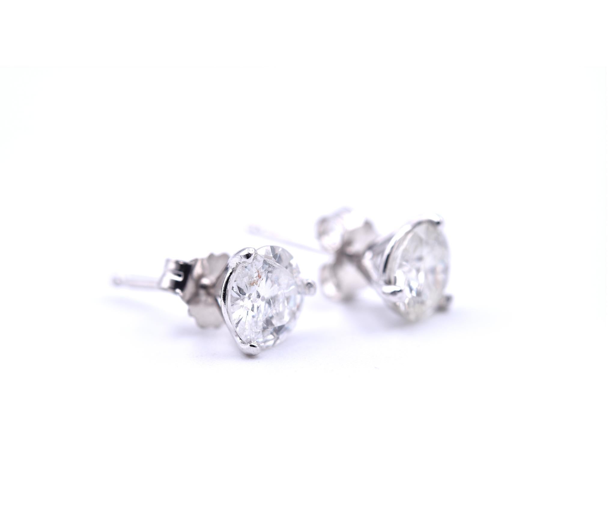 Designer: custom made
Material: 14k white gold
Diamond 1: 1 round brilliant cut = 0.74ct
Color: H-I
Clarity: SI1
Diamond 2: 1 round brilliant cut = 0.70ct
Color: G
Clarity: VS2
Dimensions: approximately 5.90mm in diameter
Fastenings: friction backs
