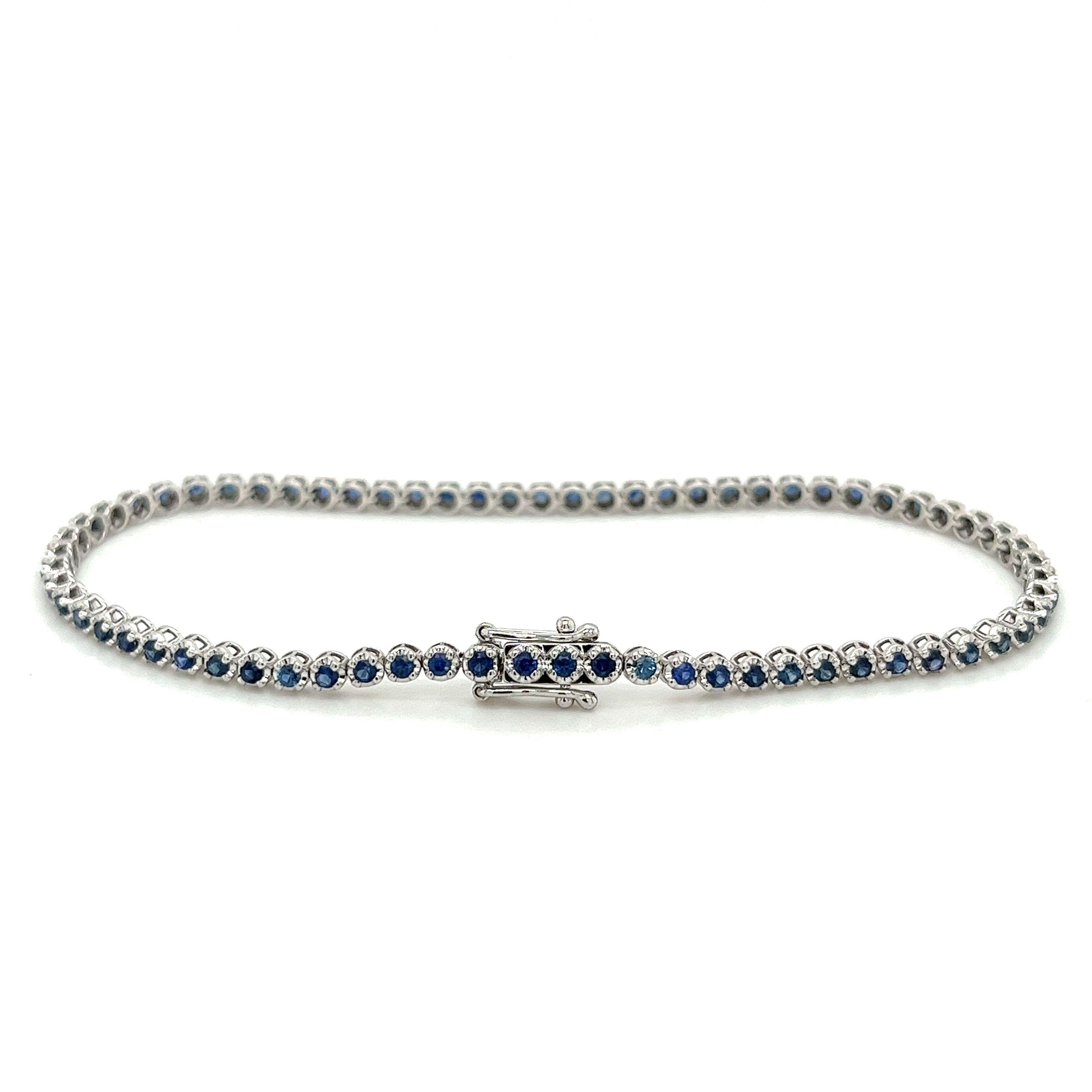 Our stunning blue sapphire round cut tennis bracelet is the epitome of luxury and elegance. Crafted from 14 karat white gold, this dainty and classy bracelet features 69 round cut blue sapphires totaling 1.67 carats.

The beautiful round cut