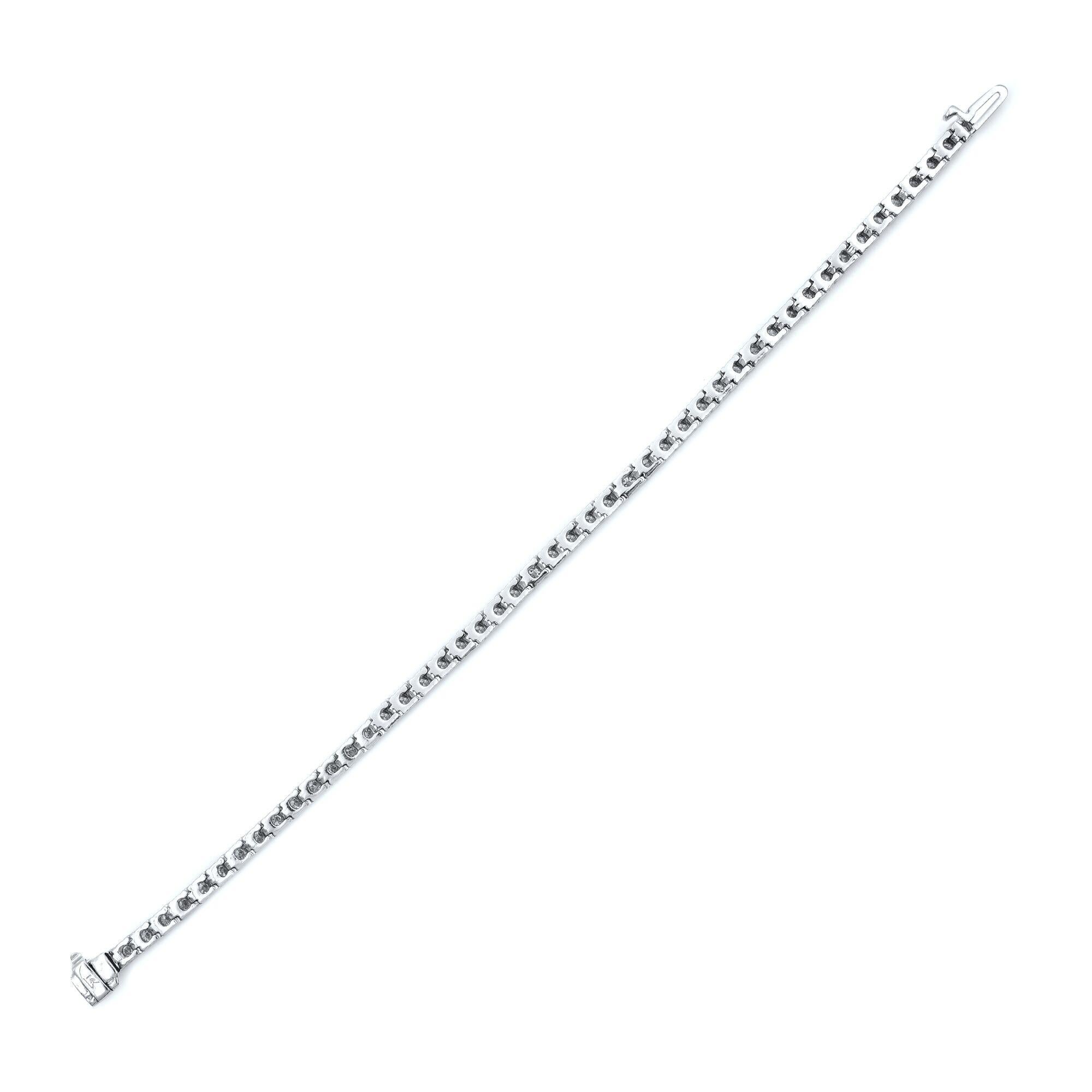 This classic and elegant tennis bracelet features 4.50 carats of brilliant round cut diamonds on a 14K white gold flexible setting. Clasp: Box catch with hidden safety. This tennis bracelet is a timeless piece that holds a place in the collection of