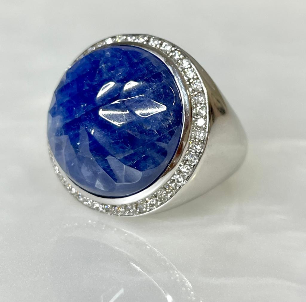 Make a statement with this supernatural unisex vintage ring featuring a 10.20 carats round shaped blue sapphire ring with rare faceted detailing surrounded by 0.39 carats of sparkling diamonds while set in solid 14K white gold.

Ring weight: 98.15