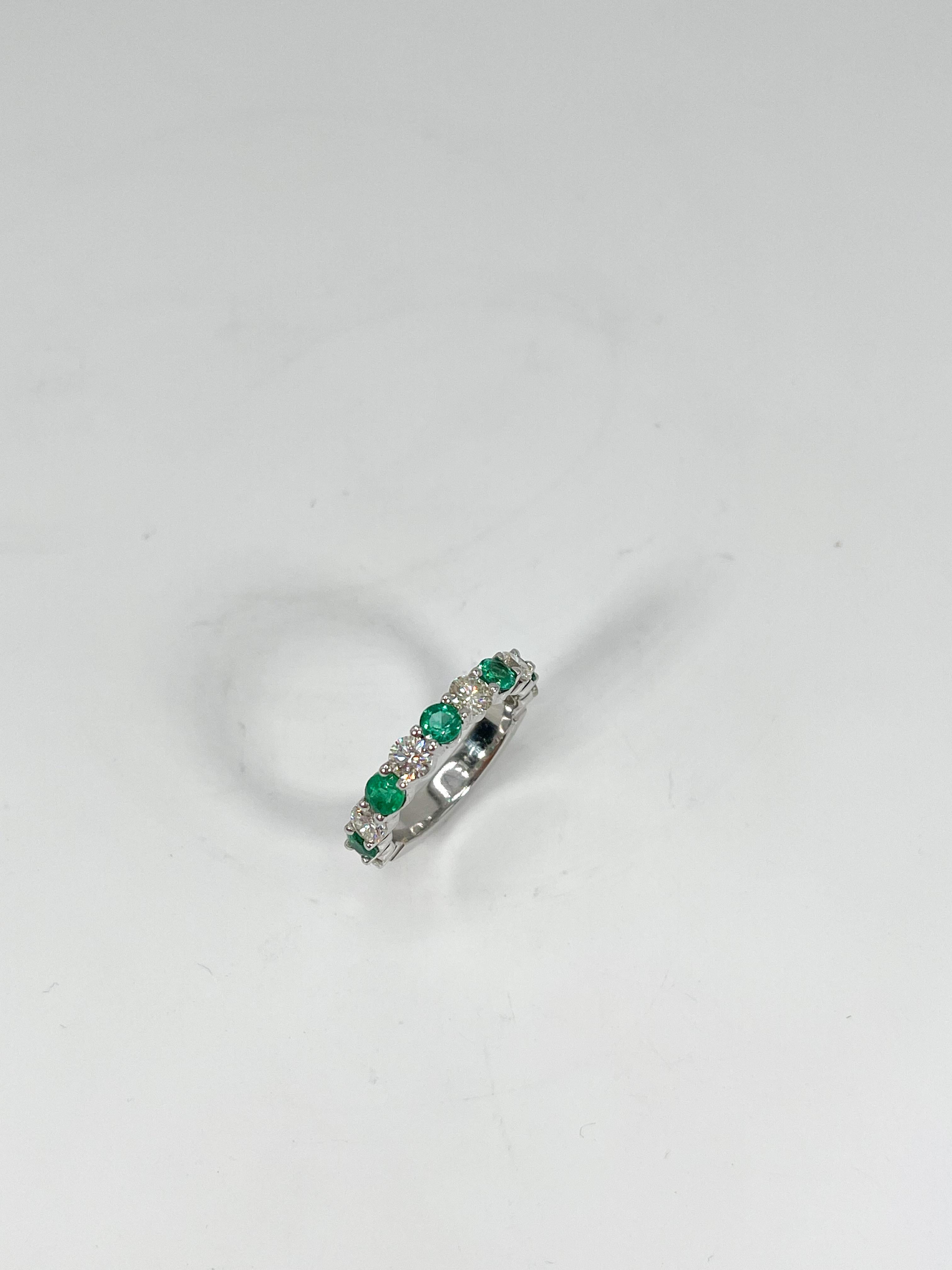 14k white gold diamond and emerald band 1.40 CTW. There are 6 diamonds and 5 emeralds alternating that go 3/4 down the shank. The ring is a size 5, has a weight of 3.69 grams, and the width of the ring is 3.5 mm.