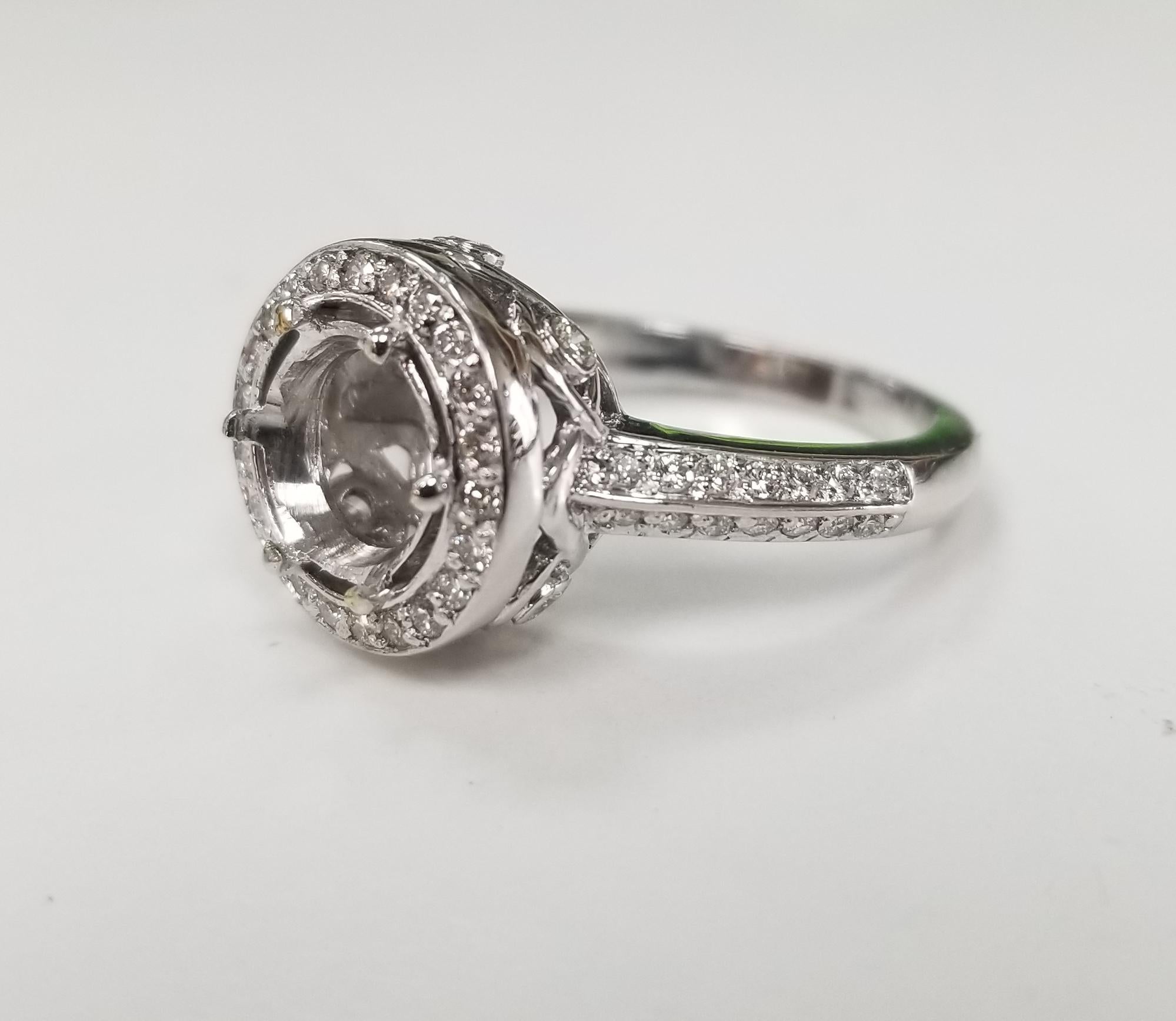 14k white gold round diamond halo ring, containing 54 round full cut diamonds weighing .65pts., color 