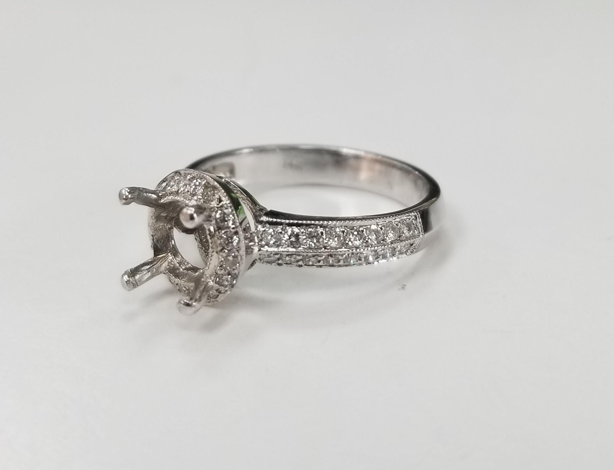 14k white gold round diamond halo with knife edge ring, containing 32 round full cut diamonds weighing .55pts., color 