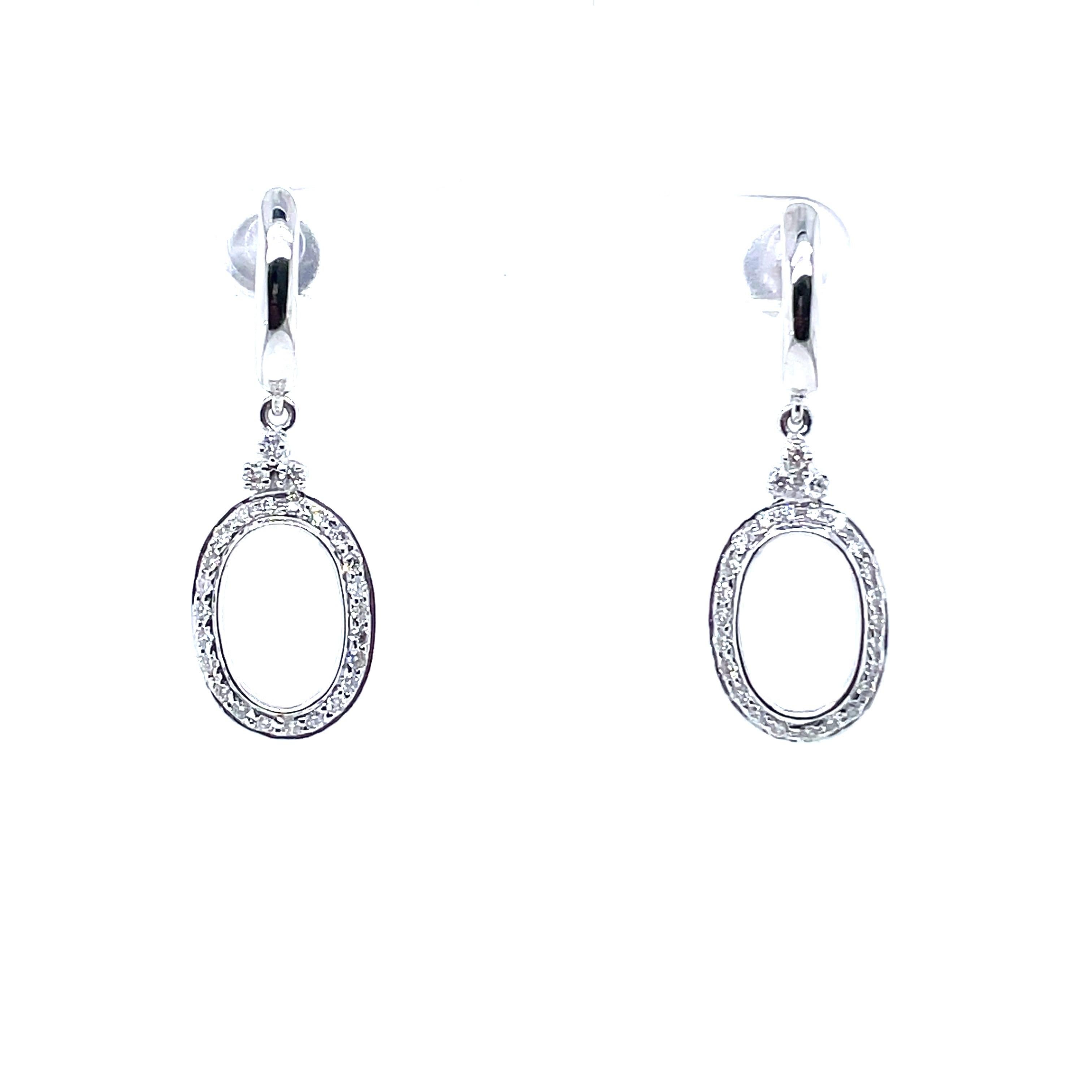 14k White Gold Round Diamond Oval Dangle Earrings

Crafted with precision, each earring features a captivating arrangement of diamonds, accentuating the oval silhouette with grace and brilliance.

Suspended by a secure push-back closure, these