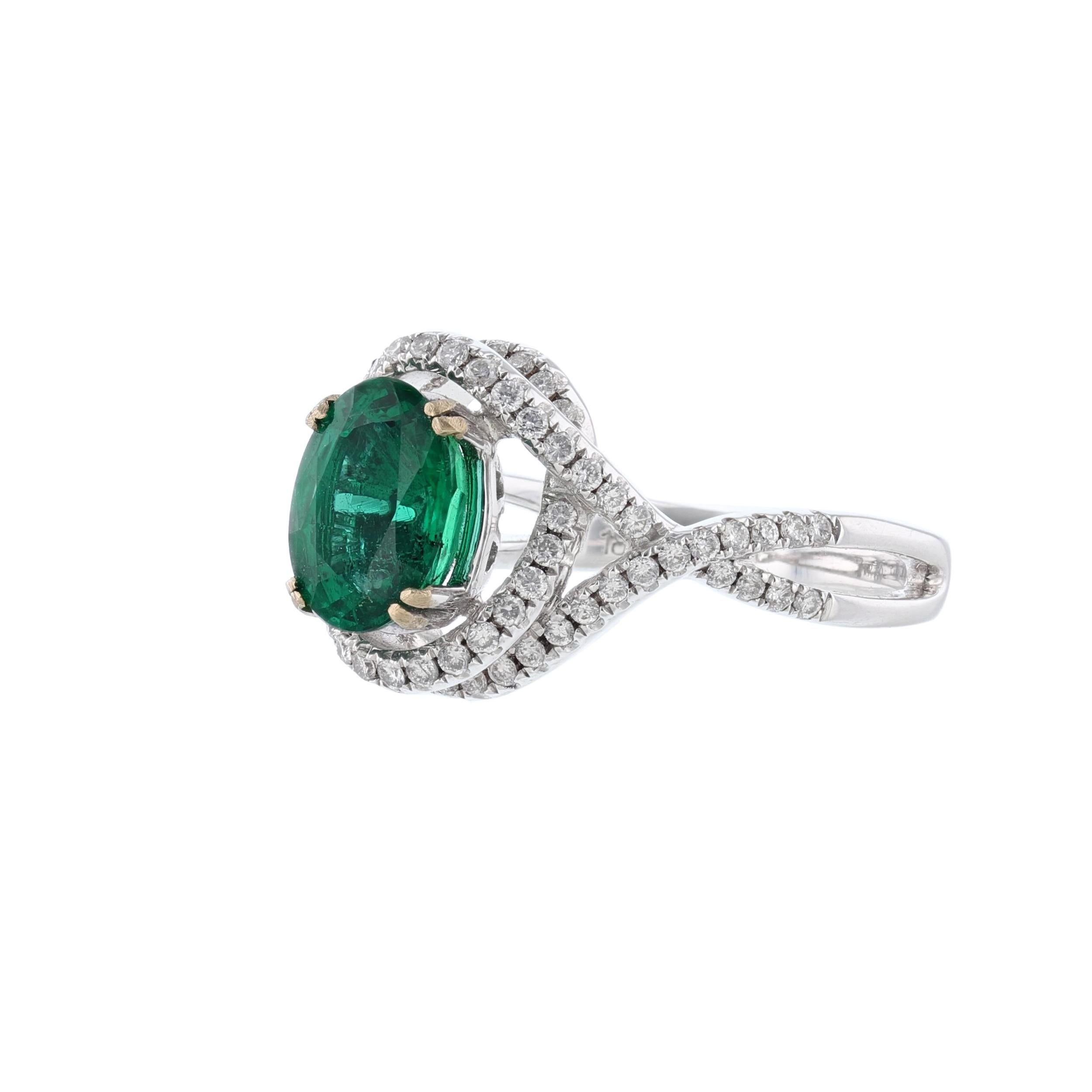 This ring is made in 14K white gold and features 1 oval cut natural beryl emerald weighing 1.70 carat. With color fancy grade (Green).  GIA Certified number 212528106. Along with 74 round cut diamonds weighing 0.40 carats. With a color grade (H) and