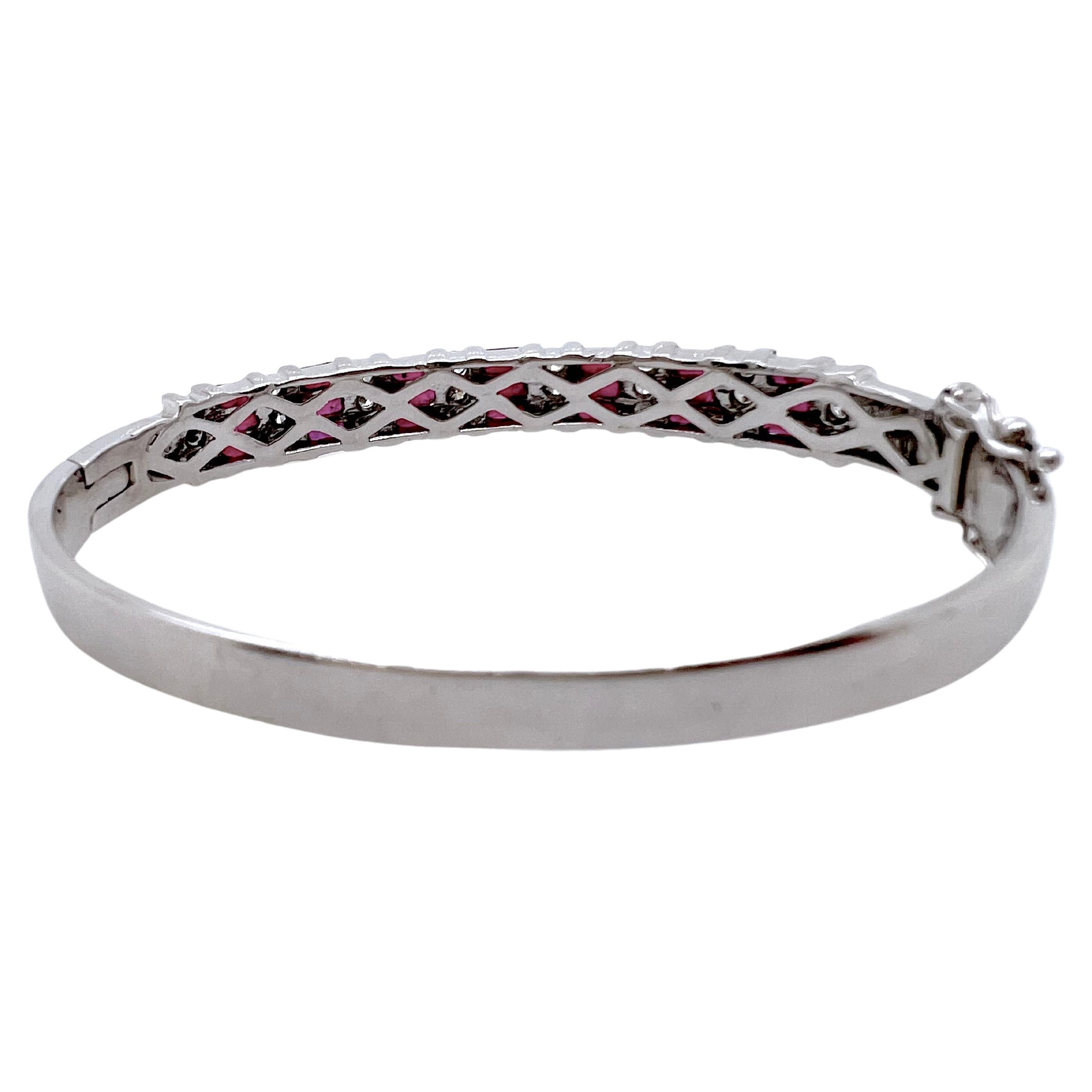This iconic bangle is made in 14k white gold and has ruby baguettes channeled set along with round diamonds channeled set.  Each section has 3 baguettes followed by 3 round diamonds which makes it symmetrical.  It is perfect for smart casual events