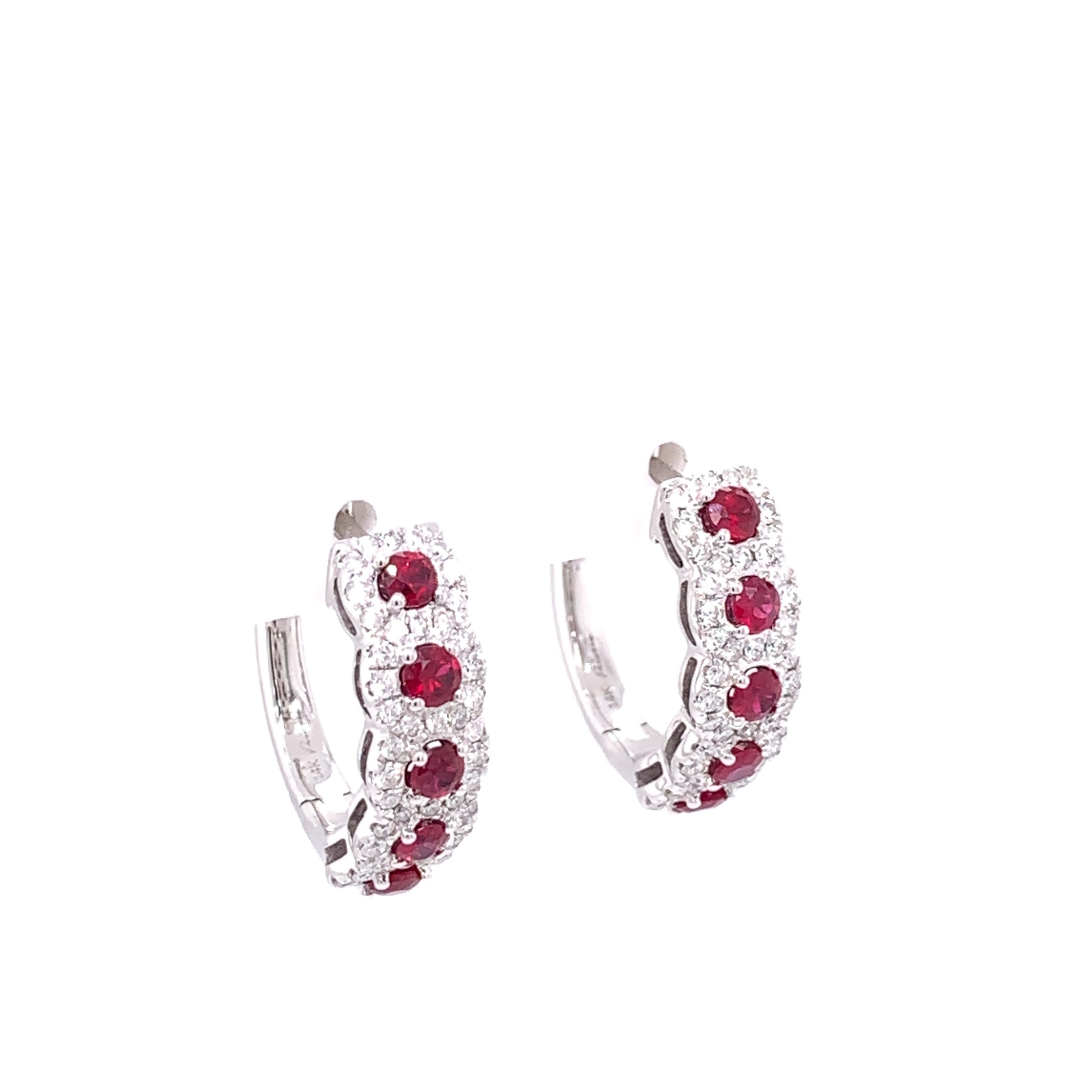 A gorgeous pair of ruby and diamond halo hoop earrings approximately 18mm which is the perfect size for everyday wear. These earrings feature 10 round ruby stones crafted in 14 karat white gold surrounded by a total of 96 round brilliant diamonds in