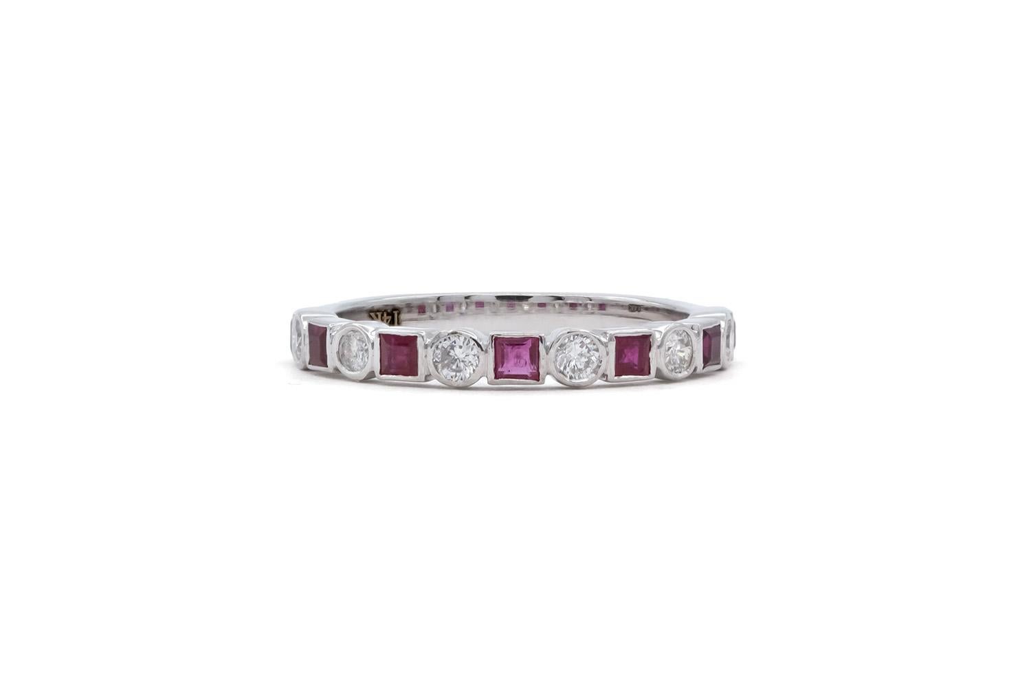 We are pleased to offer this 14k White Gold Ruby & Diamond Fashion Stacking Ring. This stunning ring feature 0.53ctw natural princess cut rubies accented by 0.24ctw H-I/SI1-SI2 round brilliant cut diamonds all bezel set in a 14k white gold mounting.