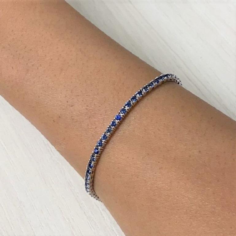 Quality Bracelet: Crafted of 14k yellow gold this bracelet features 63 Round Sparkling Sapphires, Sapphires weighing 4.60 carats. Hinged Clasp Closure. 7 Inches in length.
 Surprise Your Loved Ones with Our Sapphire Bracelet For Her: If you are