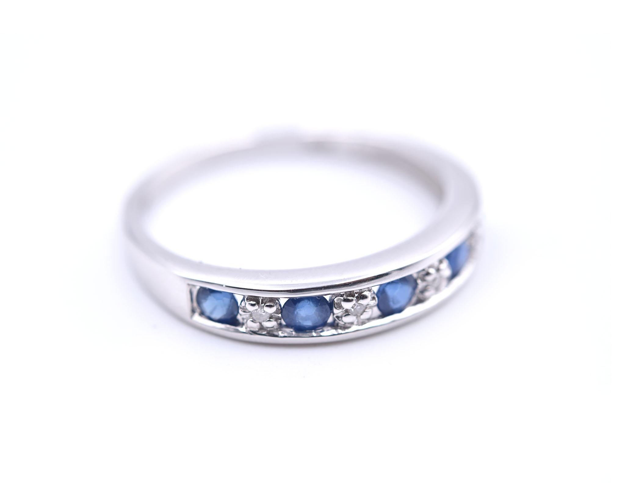 Designer: custom design
Material: 14k white gold
Sapphire: 5 sapphire round cut= .25cttw
Diamonds: 4 round cut= .02cttw
Color: G	
Clarity: VS
Ring size: 7 (please allow two additional shipping days for sizing requests)
Dimensions: ring is 3.95mm
