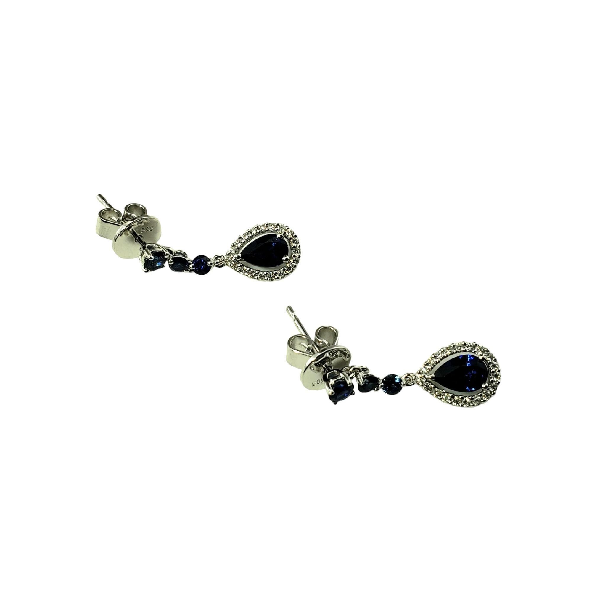 14 Karat White Gold Sapphire and Diamond Drop Earrings JAGi Certified-

These elegant drop earrings each features one pear cut sapphire, three round sapphires, and 19 round brilliant cut diamonds set in classic 14K white gold.  Push back