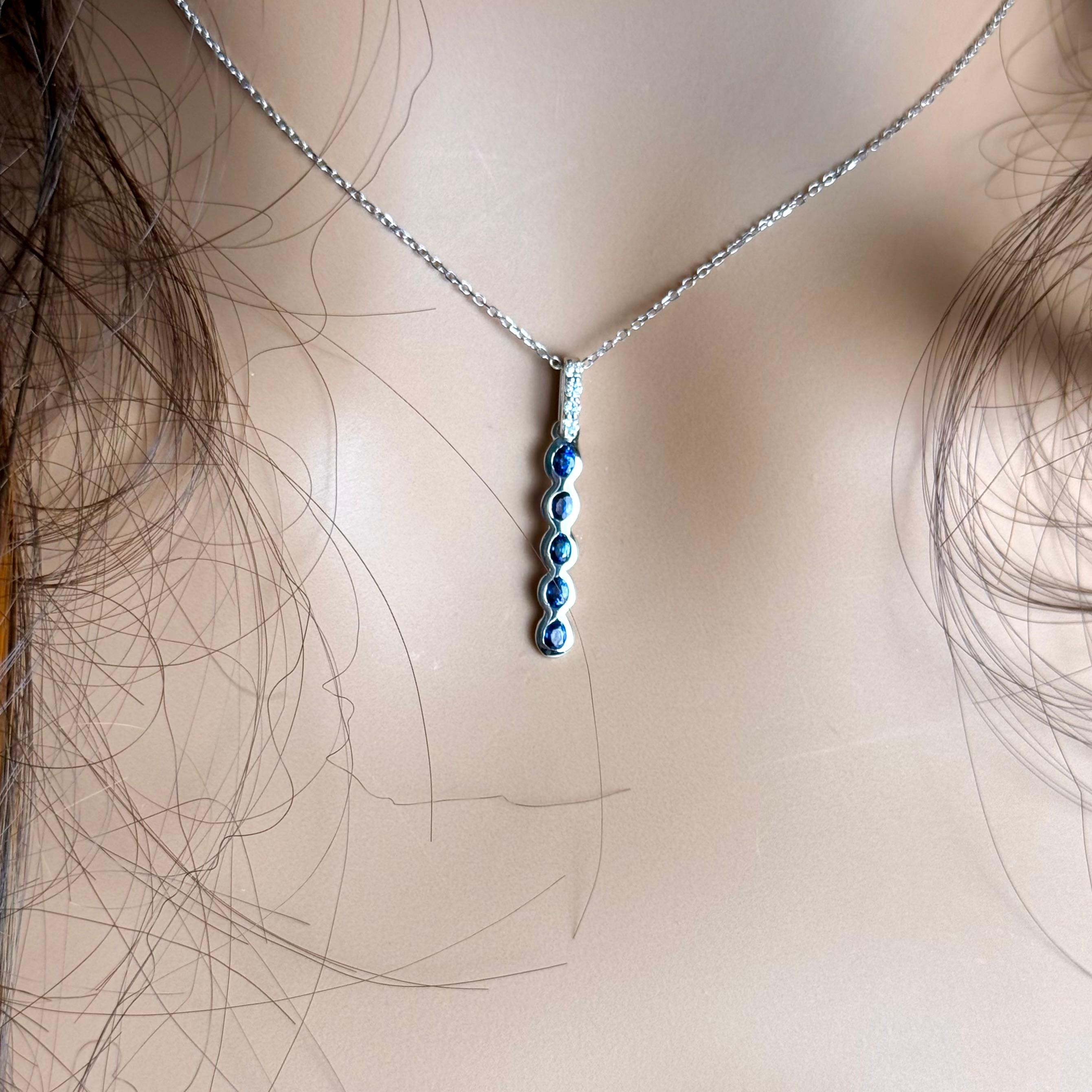A graceful expression of refined luxury, this 14K White Gold necklace showcases a stunning linear drop pendant adorned with richly colored natural sapphires and sparkling diamonds — a perfect balance of delicate design and vibrant beauty.

Suspended