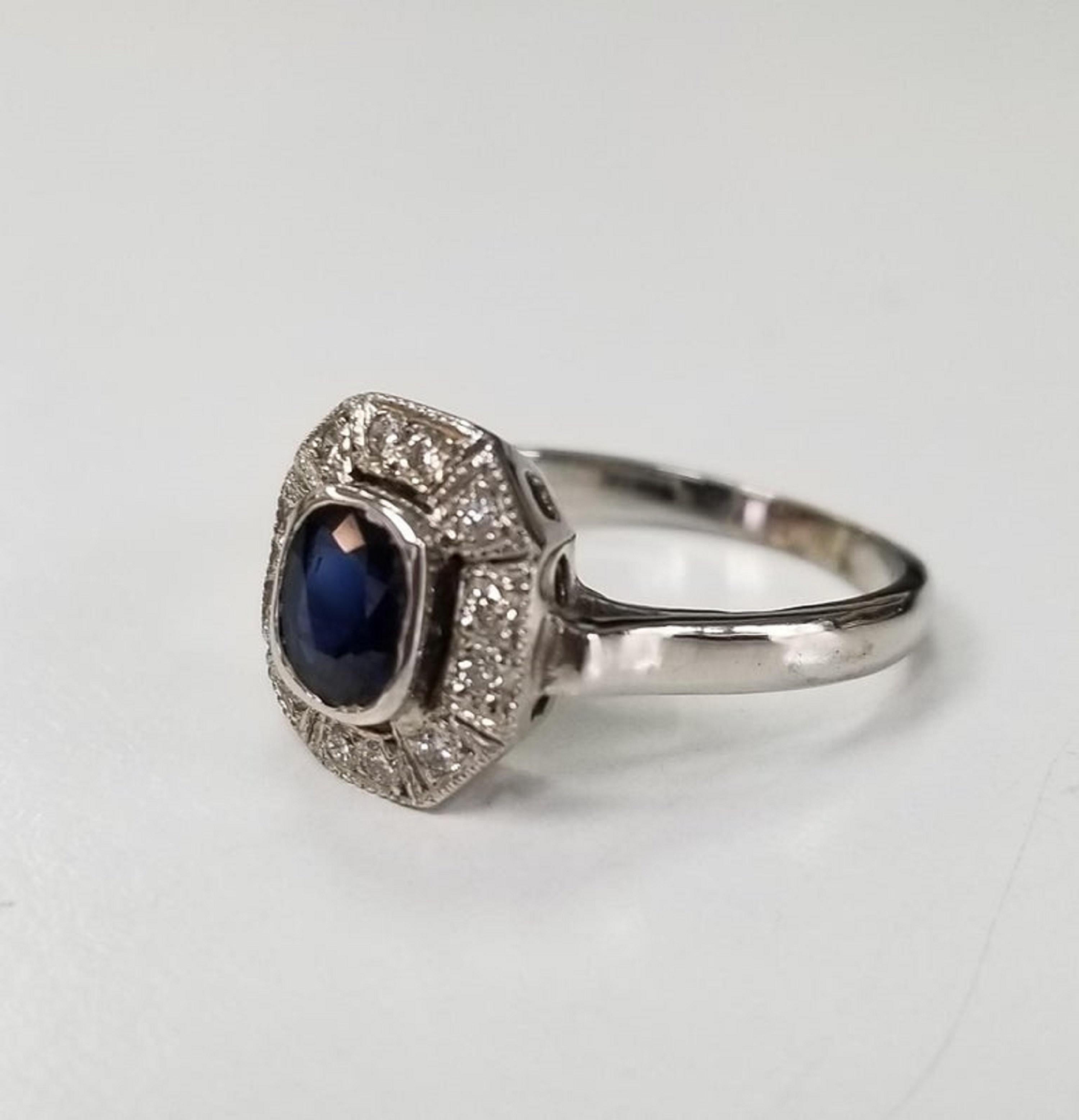14k white gold Sapphire and diamond  ring, containing 1 oval sapphire weighing .75pts. and 12 round full cut diamonds of very fine quality weighing .15pts.  This ring is a size 6 but we will size to fit for free.