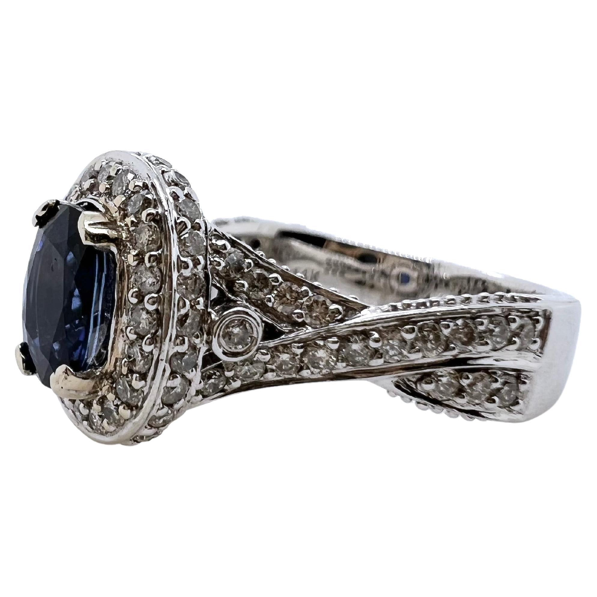 This beautiful sapphire is set in a gorgeous setting!  The scroll, wrap style diamond setting elevates and holds the sapphire in a higher profile to further accentuate the sapphire.  The ring is an excellent addition to your jewelry