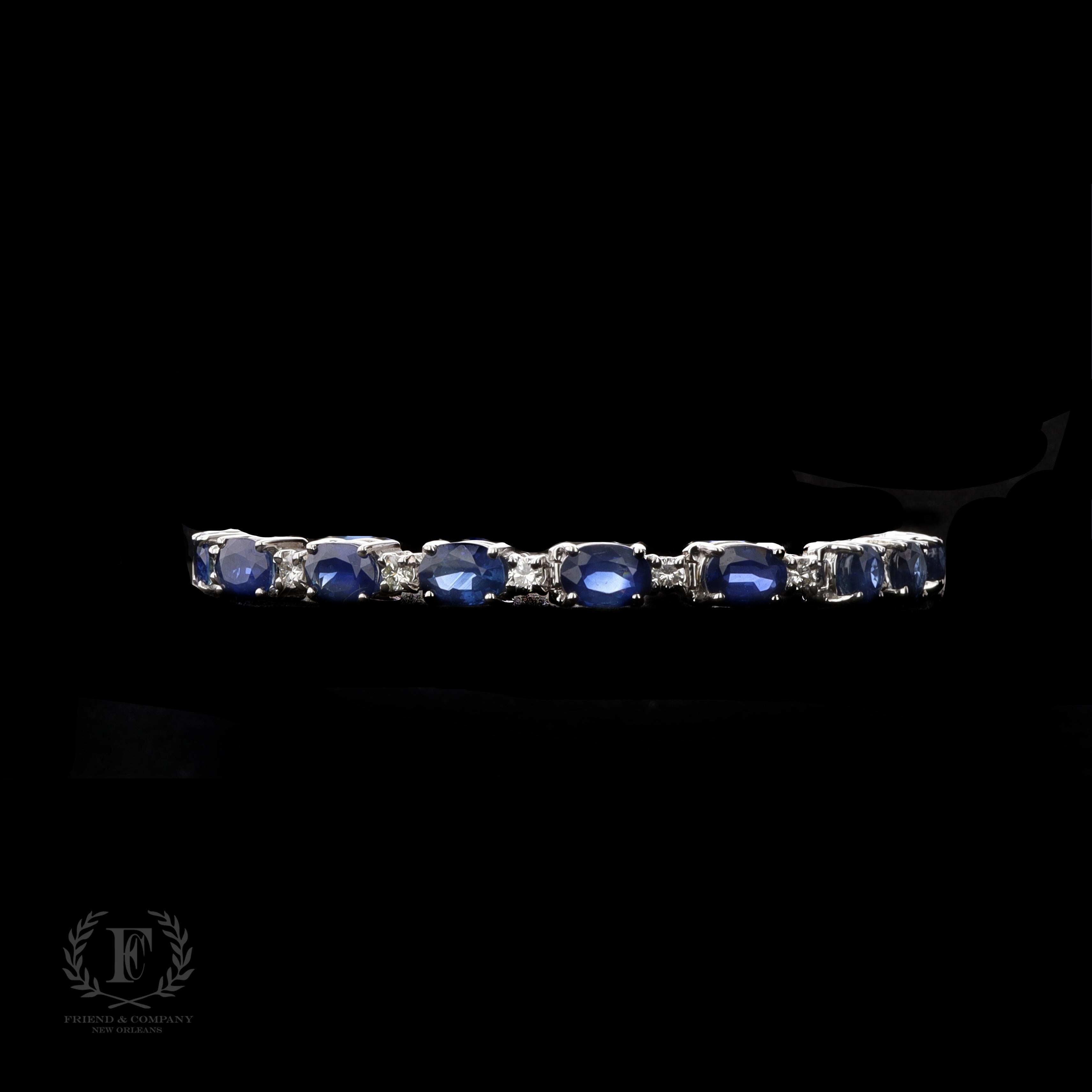 This stunning sapphire and diamond bracelet is a piece to cherish for a lifetime. It is crafted in 14 karat white gold and features 17 oval cut blue sapphires with a total weight of 14.28 carats. The bracelet also contains 18 round cut diamonds with