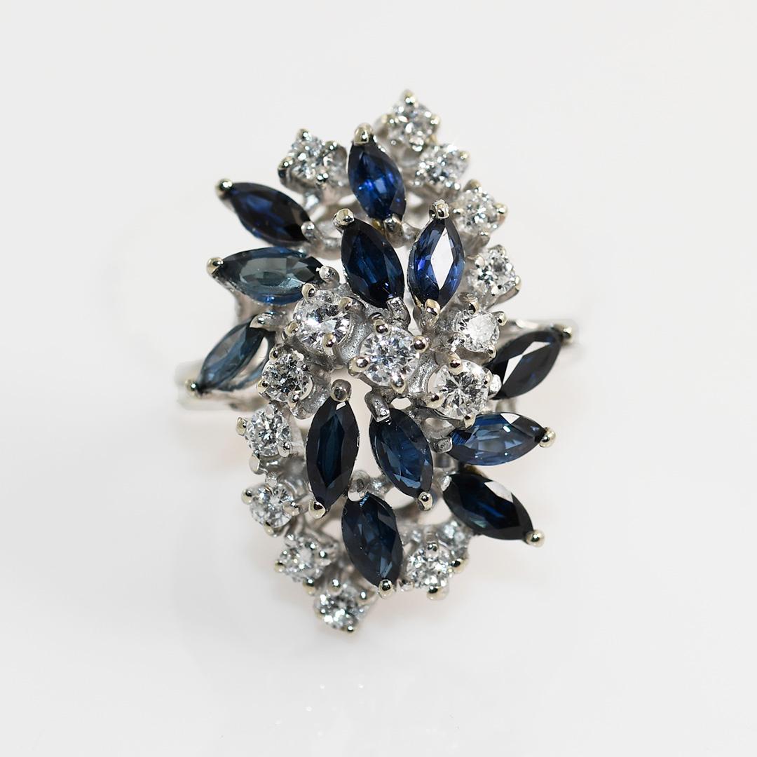 14k White Gold Diamond and Sapphire Cluster Ring.

The Sapphires are Marquise cuts, medium to dark blue color.

Diamonds are Round Brilliant Cut G-H Color, SI1-SI2 Clarity. 1.00tcw

Stamped 14k, but test 55% pure on x-ray gun. Weighs 7.8gr

Size 7,