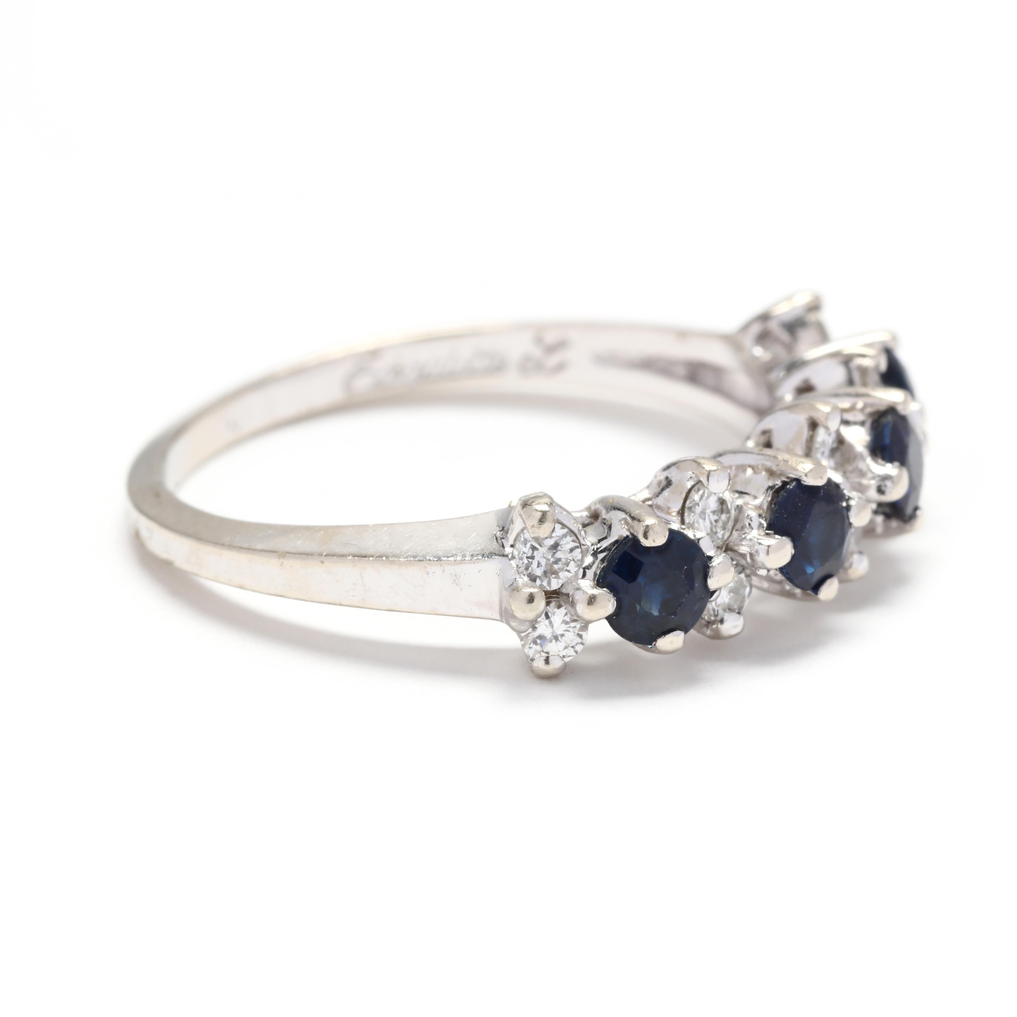 A 14 karat white gold, sapphire and diamond stackable band ring. This ring features alternating round cut sapphires weighing approximately .64 total carats and full cut round diamonds weighing approximately .20 total carats, with a slightly tapered