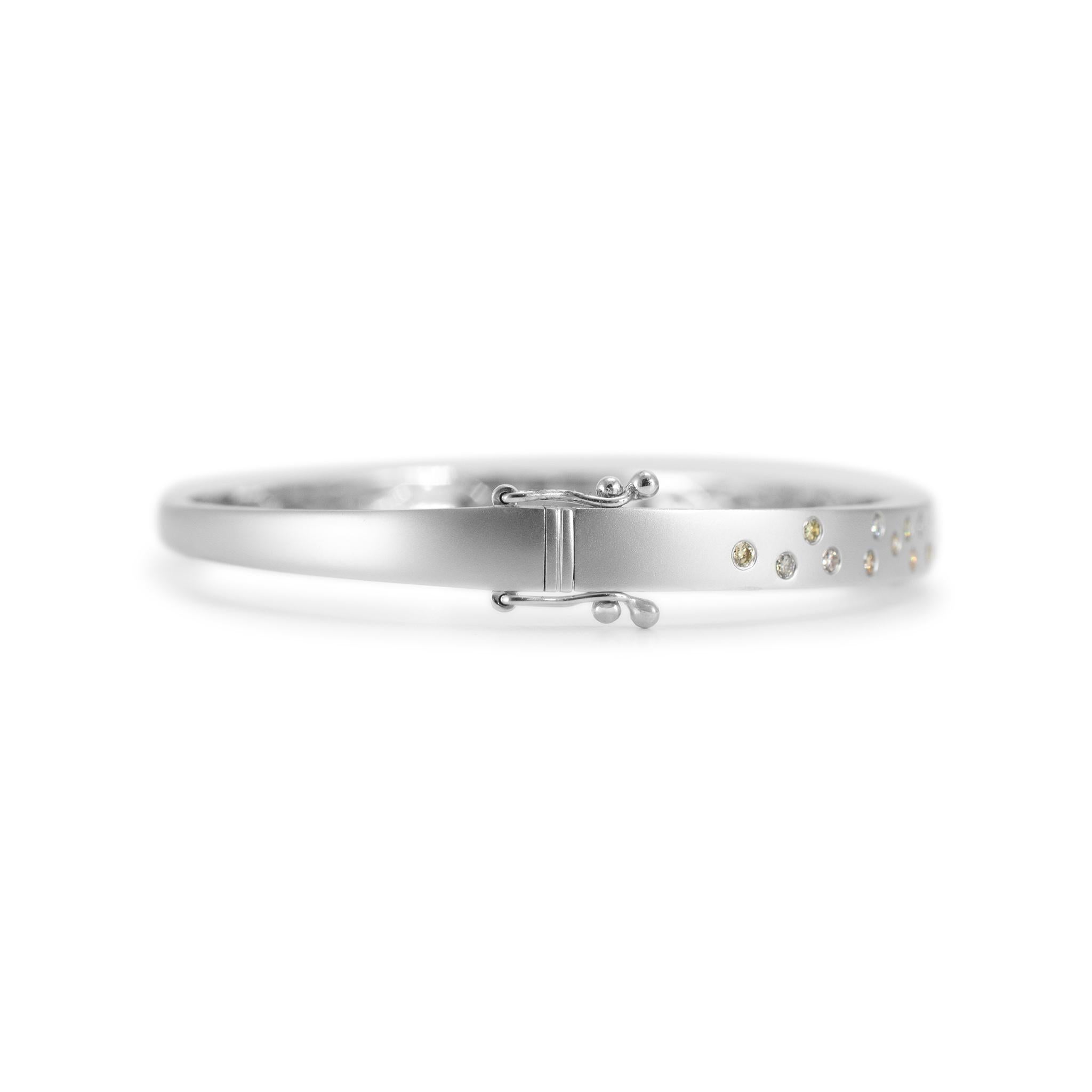Gender: Ladies

Metal Type: 14K White Gold

Length: 6.75 inches

Width: 5.00 mm tapering to 3.05 mm

Weight: 13.75 grams

14K White Gold diamond bangle bracelet. The metal was tested and determined to be 14K white gold. Engraved with 