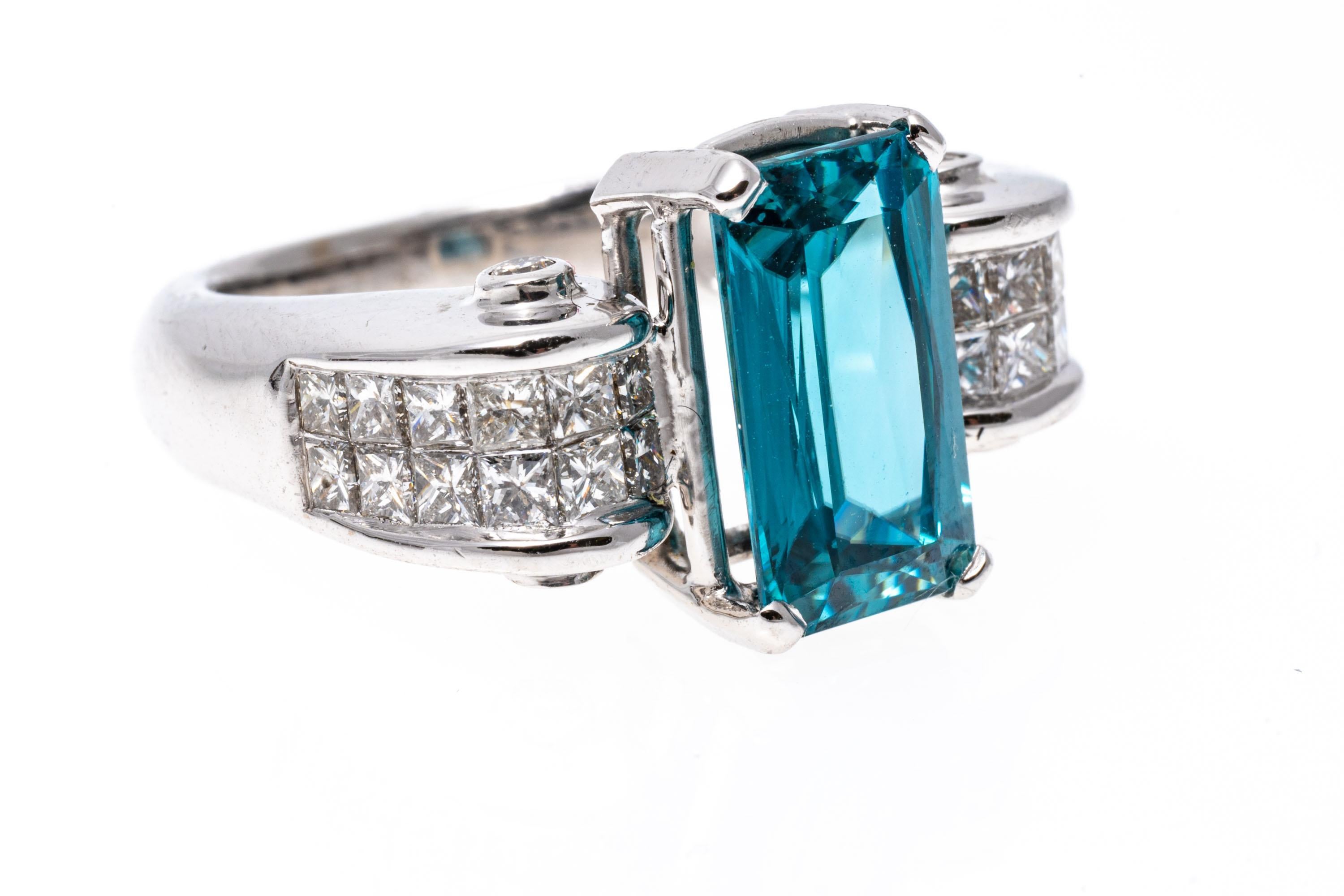 Contemporary 14k White Gold Scrolled Calibre Princess Cut Diamond And Blue Topaz Ring For Sale