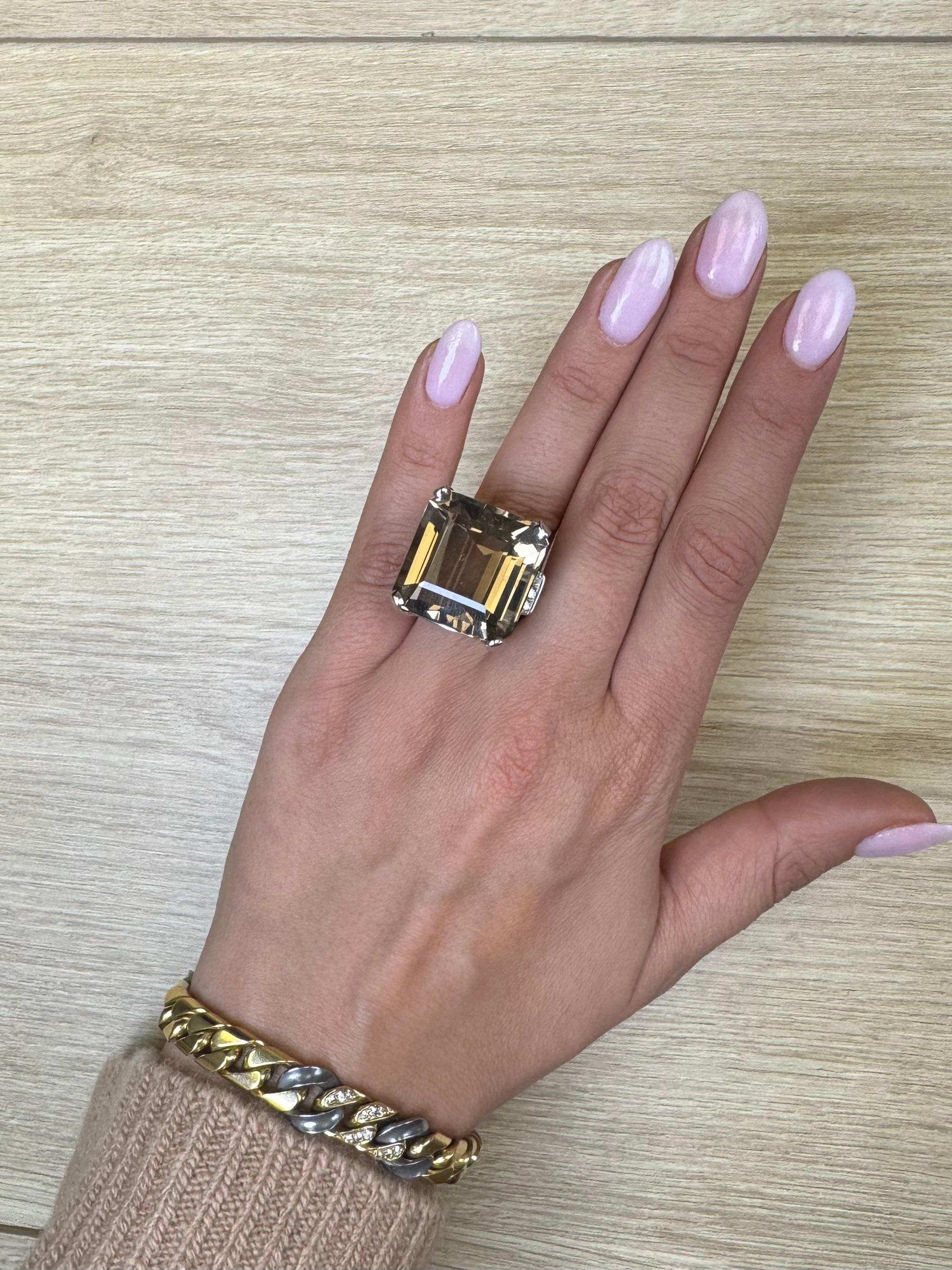 A striking statement piece from the Mid-Century era, this bold cocktail ring showcases a large, square-cut smoky quartz set in 14K white gold. The richly hued quartz—known for its warm, earthy tones—measures approximately [insert estimated carat